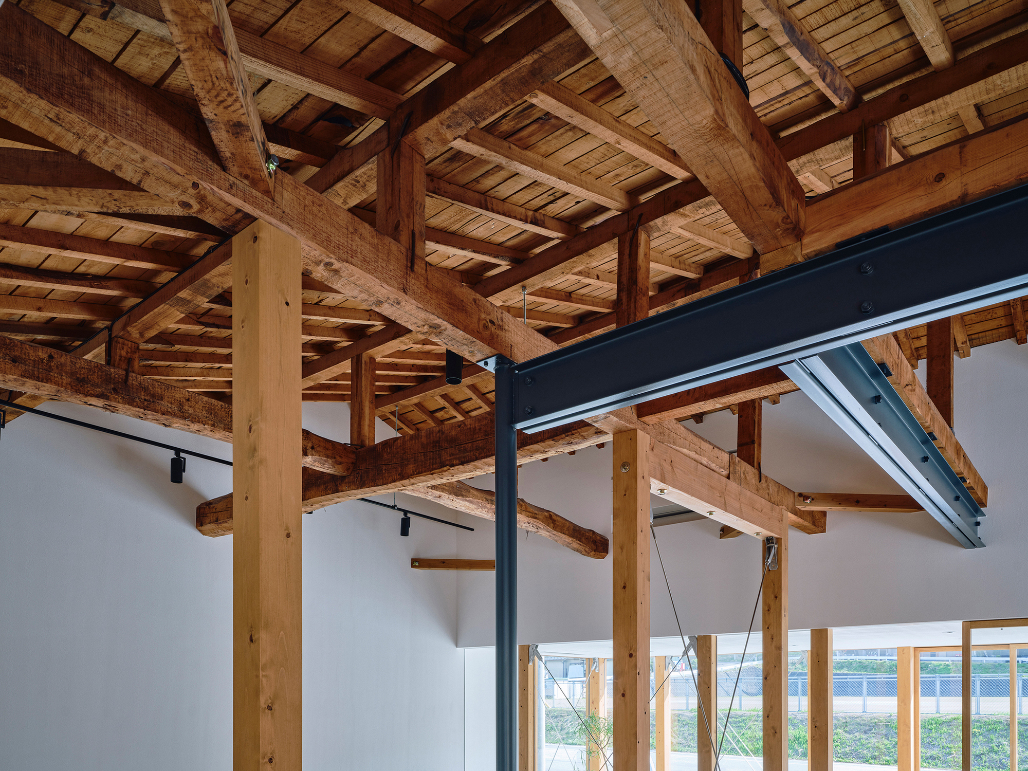 Detail of the exposed timber post and beam structure with steel reinforcement plates and cable tension elements