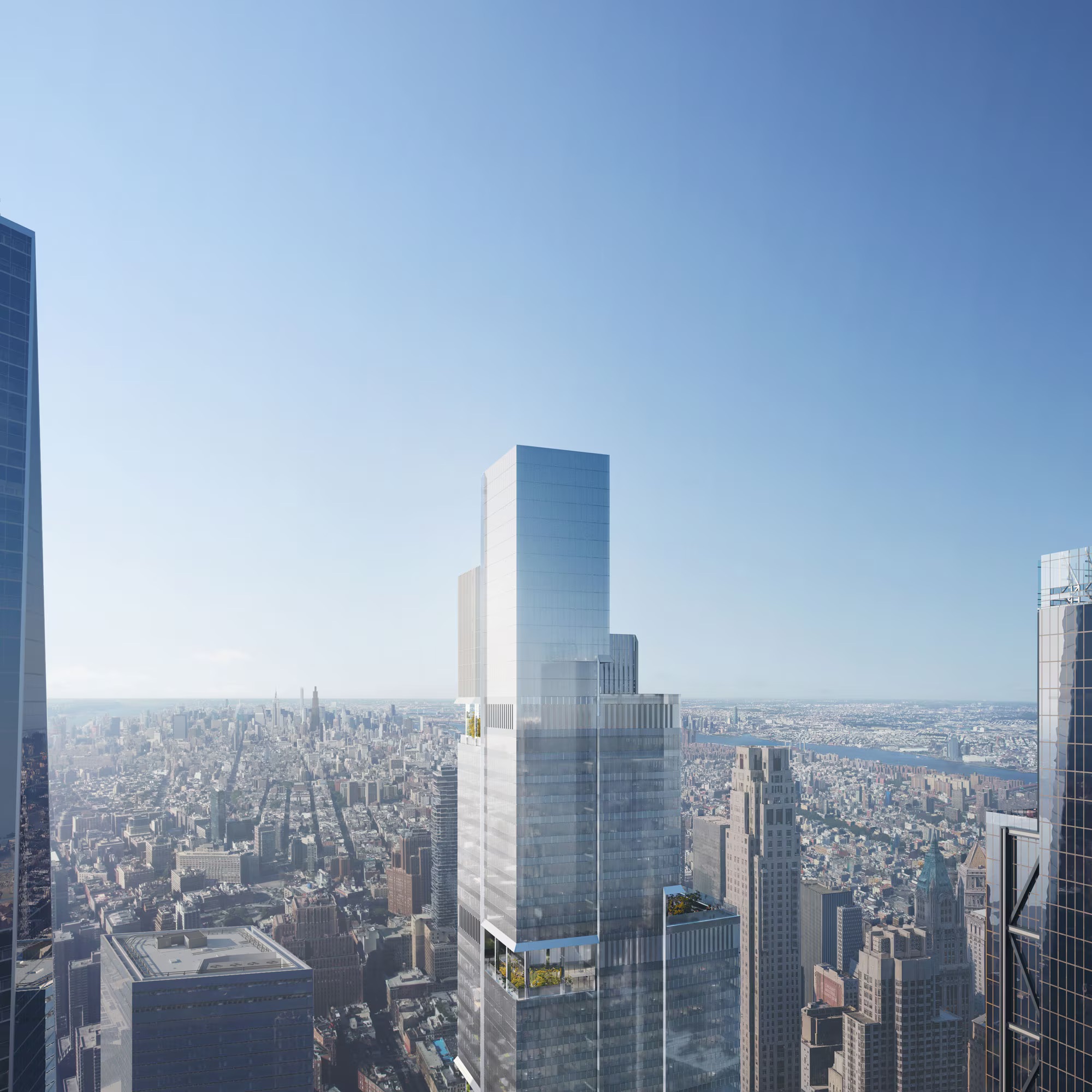 Aerial view of the stepped glass tower above the dense urban fabric