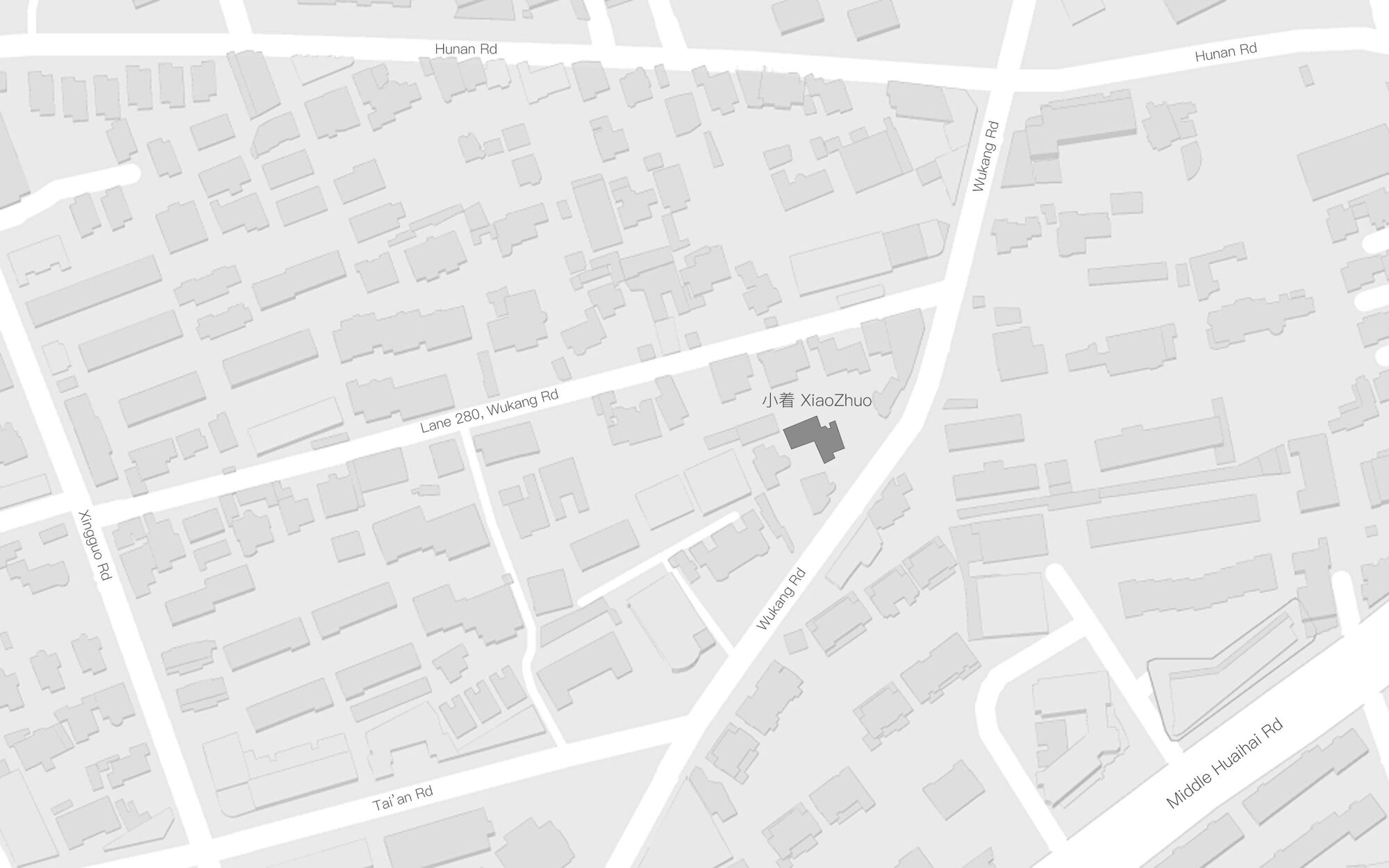 Site plan showing building footprint highlighted in dark grey within a network of urban blocks and streets
