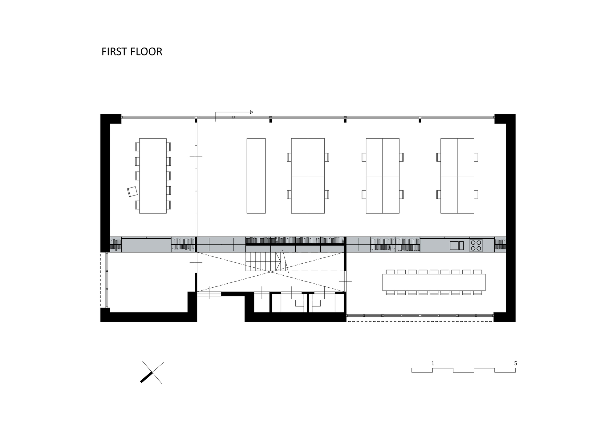 First floor plan showing workspace areas, central stair void, and terrace extension