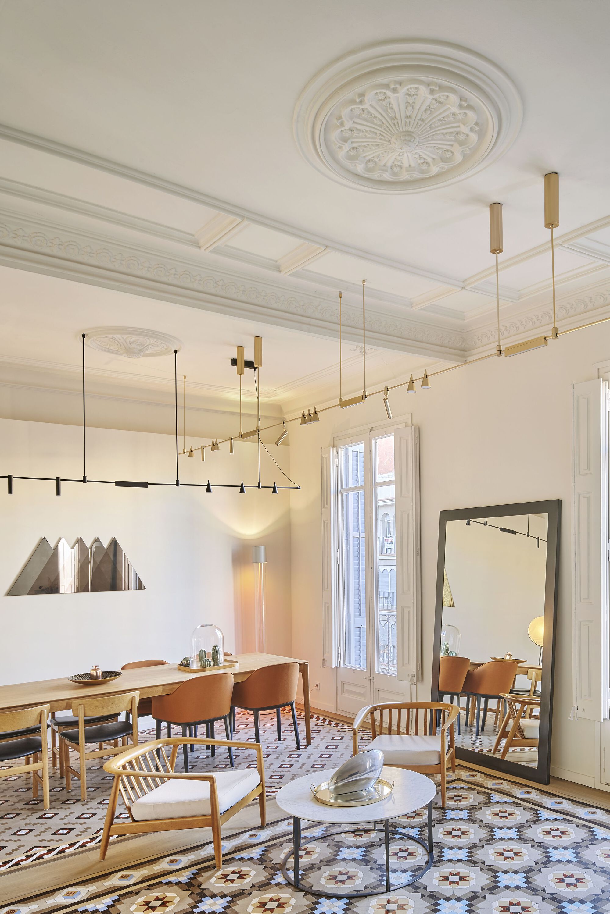 Diagonal view of the living room showing the ornamental ceiling medallion and brass lighting fixtures