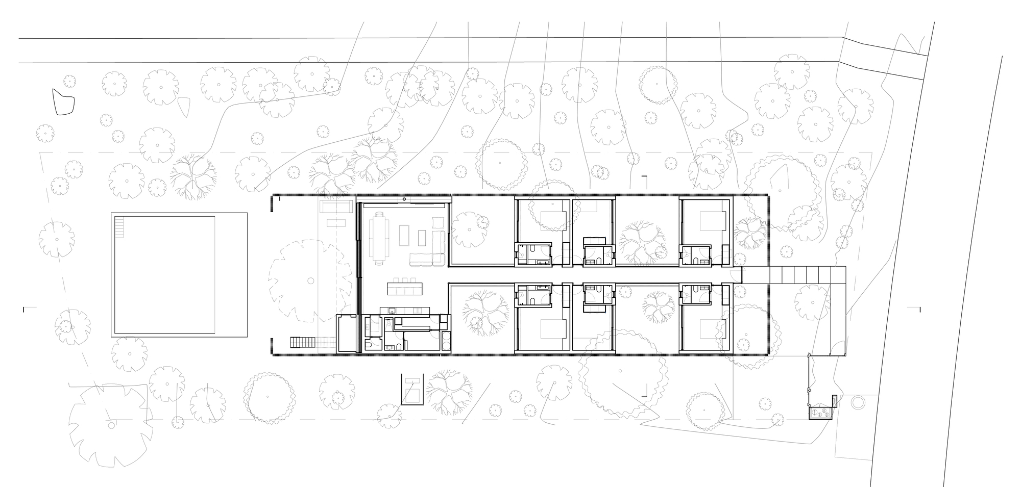 Site plan drawing showing a linear residential volume nestled among trees on sloping terrain
