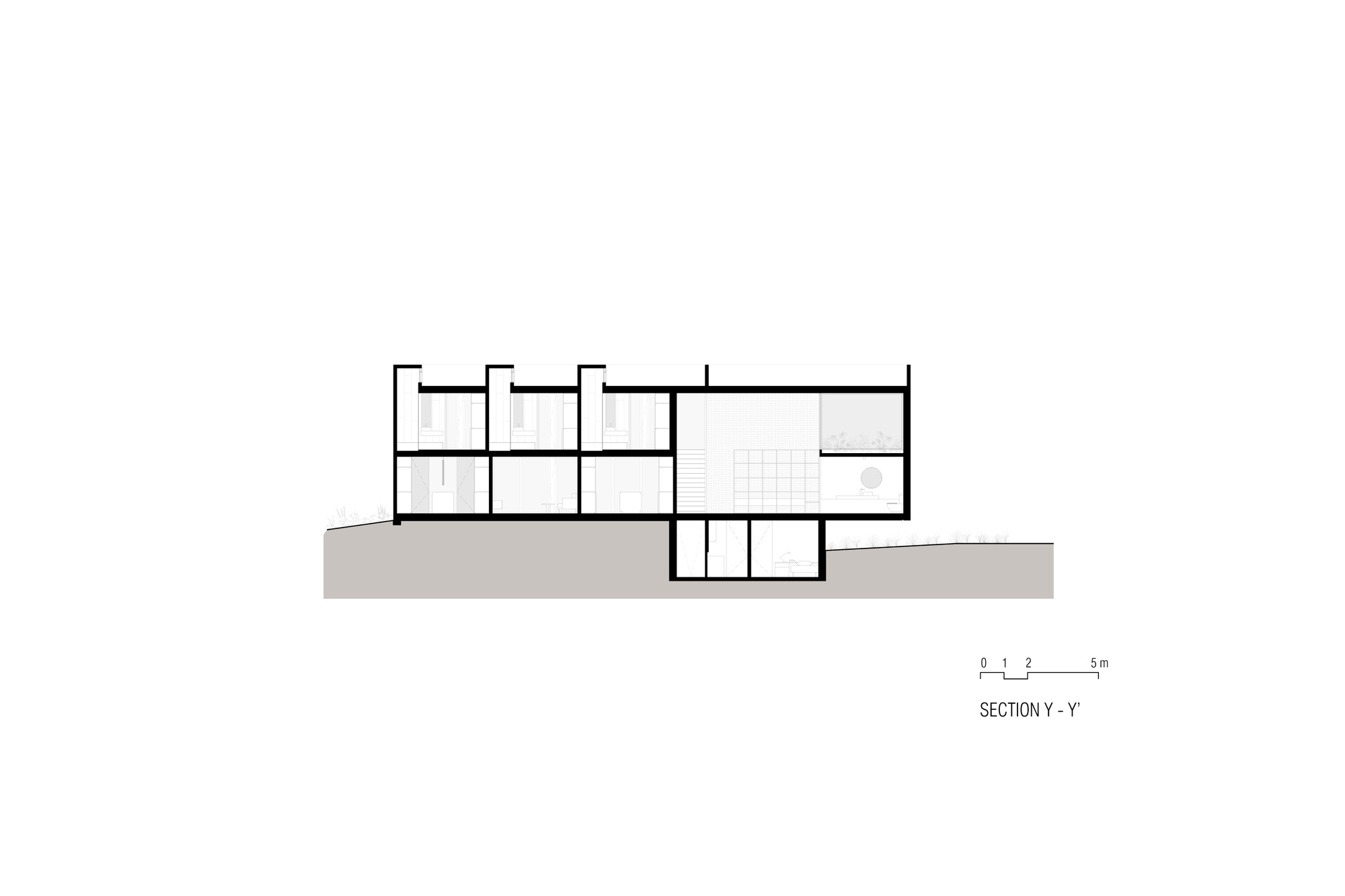 Section drawing revealing a two-story volume with interior spaces stepping down into the ground