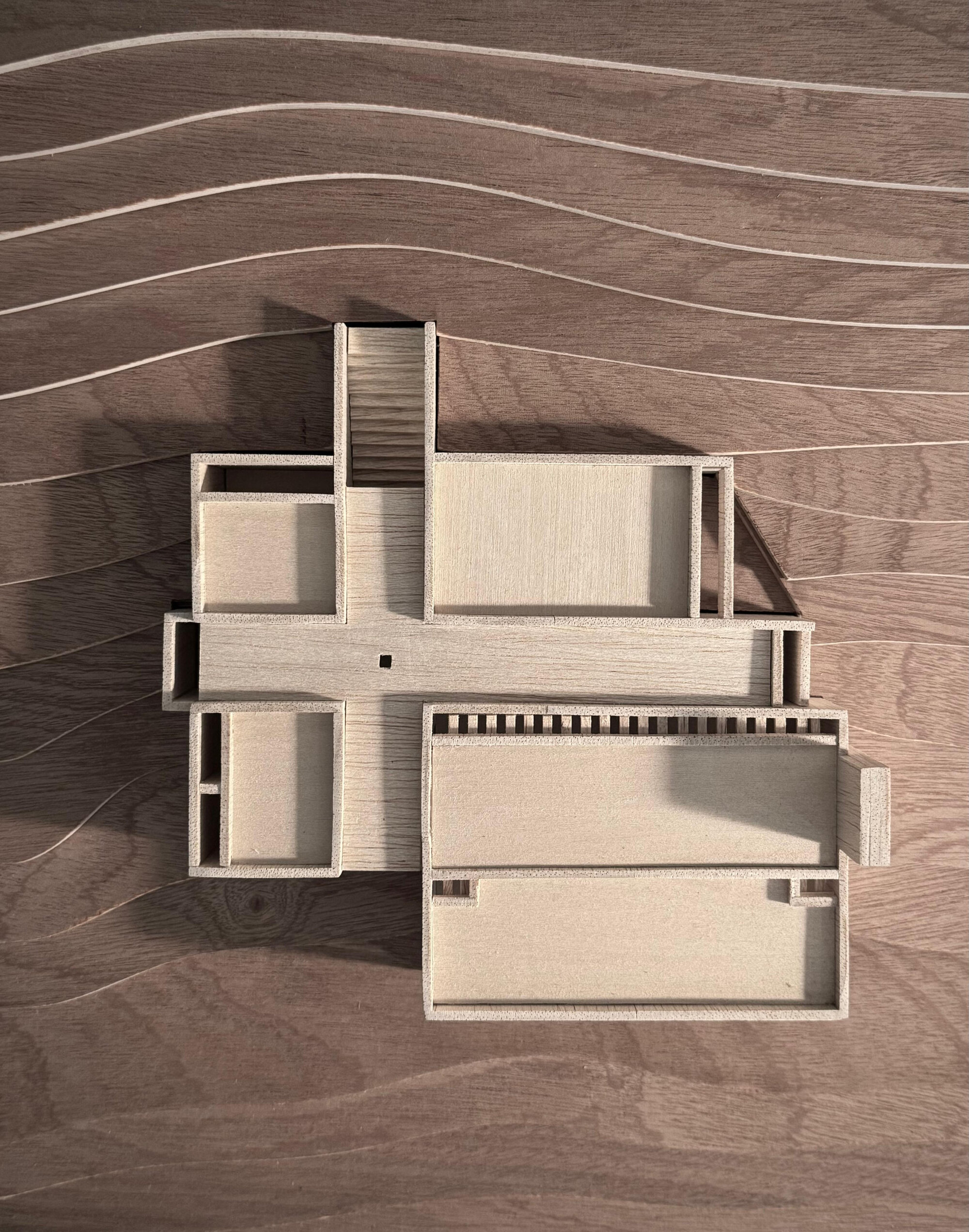 Top view of the physical study model in light wood on a wooden surface