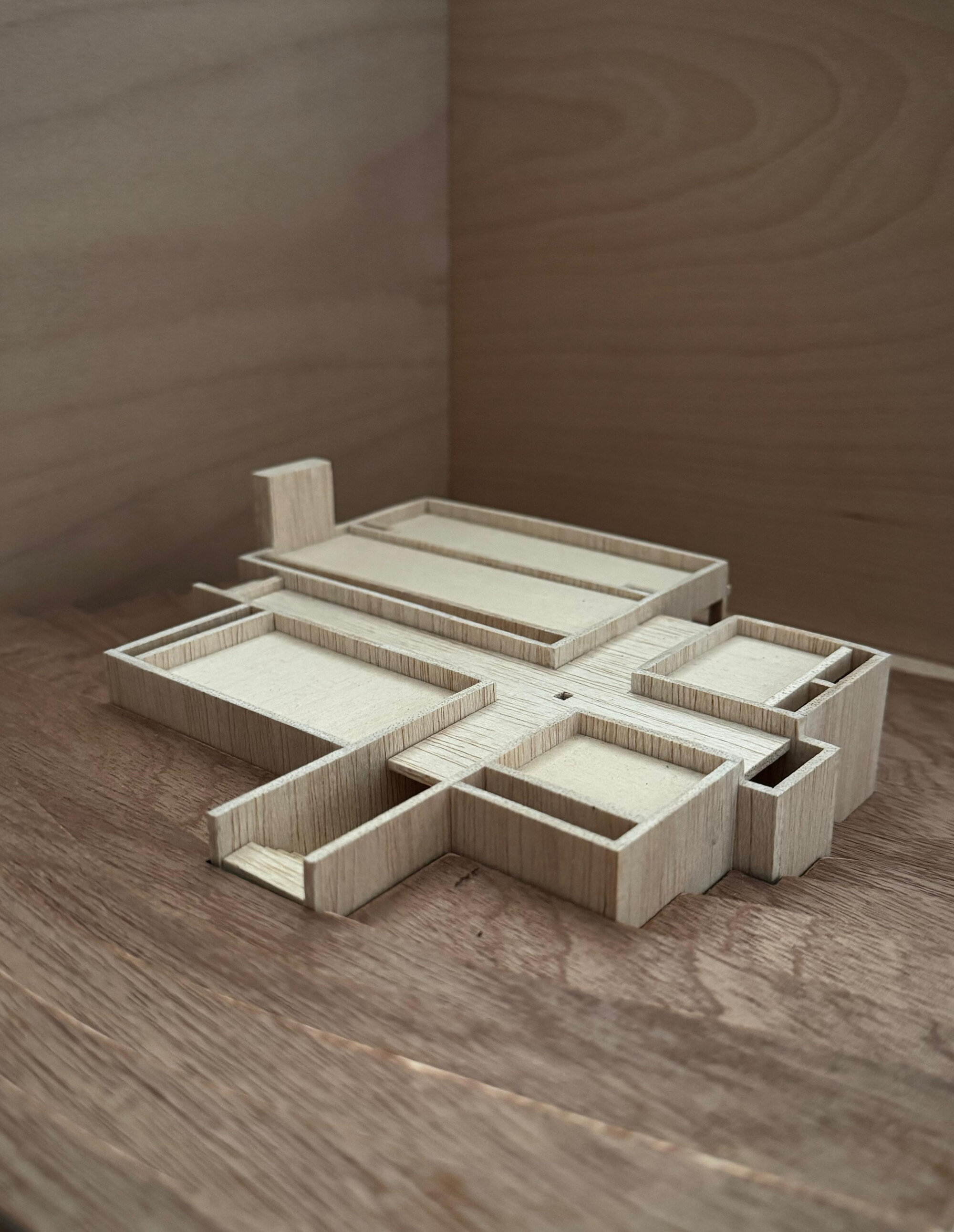 Oblique view of the layered wood study model showing terraced volumes in shadow