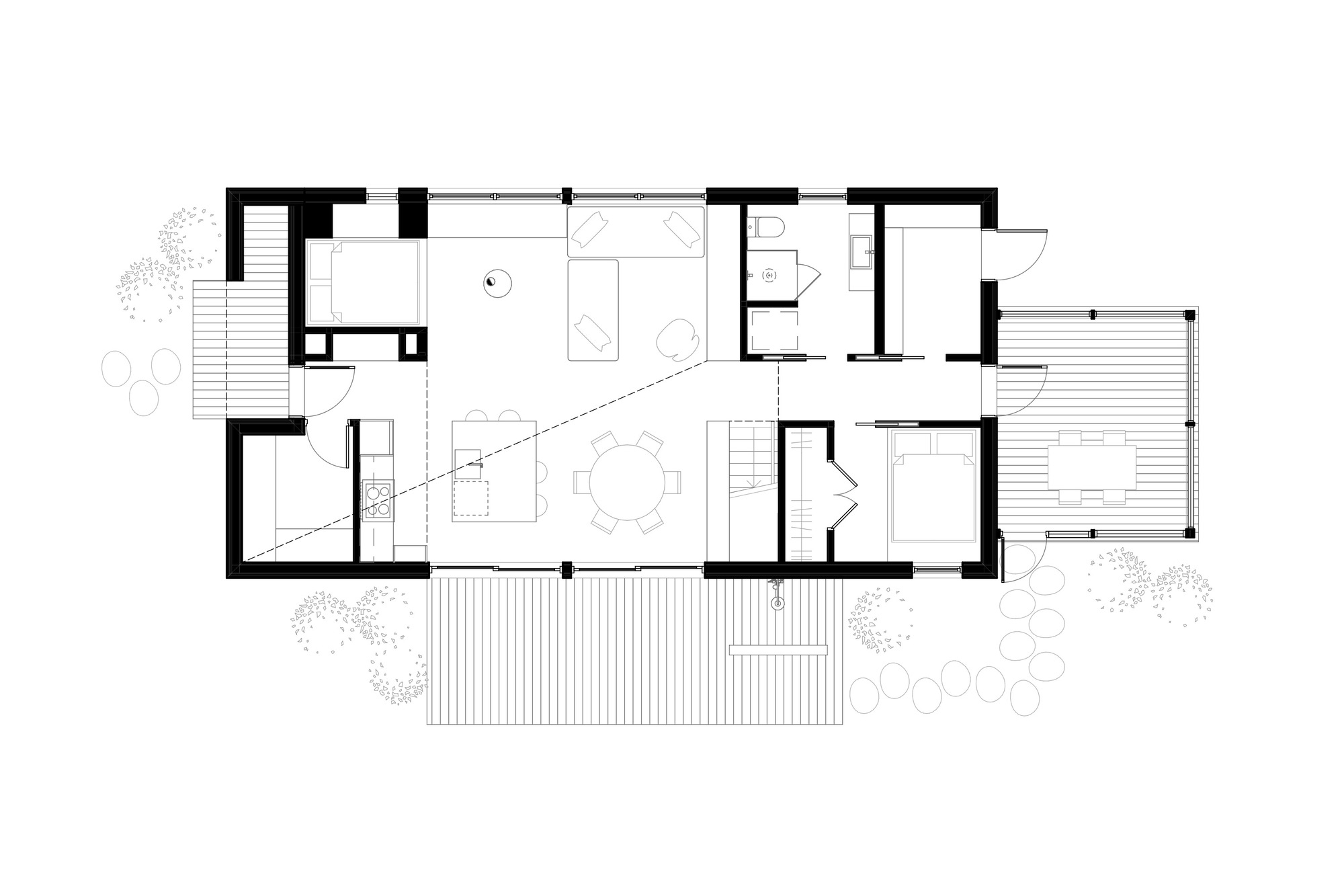 Floor plan showing open living and dining areas with exterior decks and surrounding vegetation