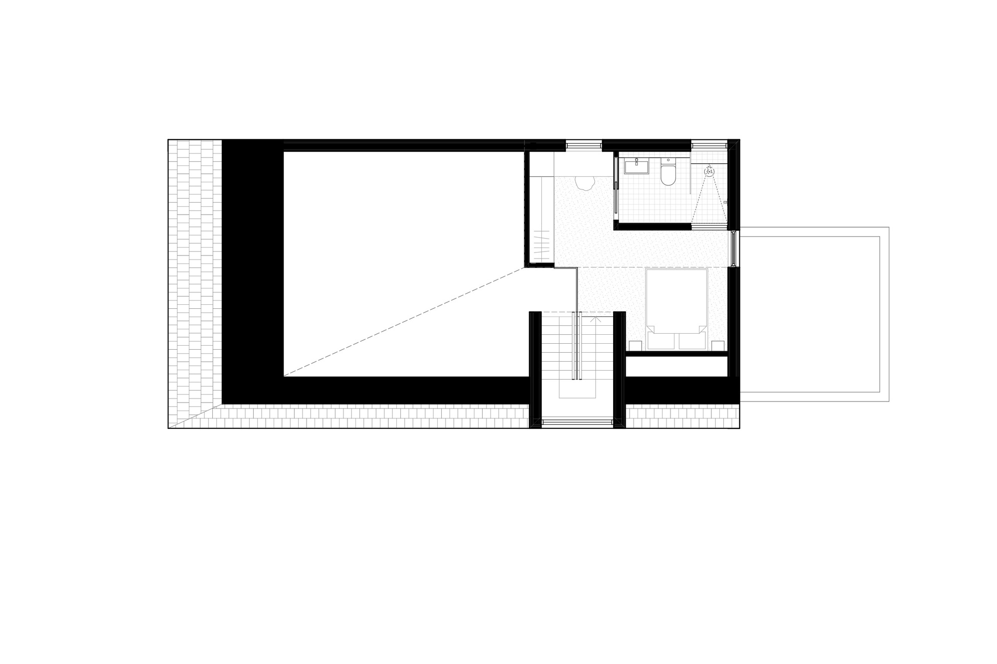 Upper level floor plan with central stairwell connecting a large open space and bathroom