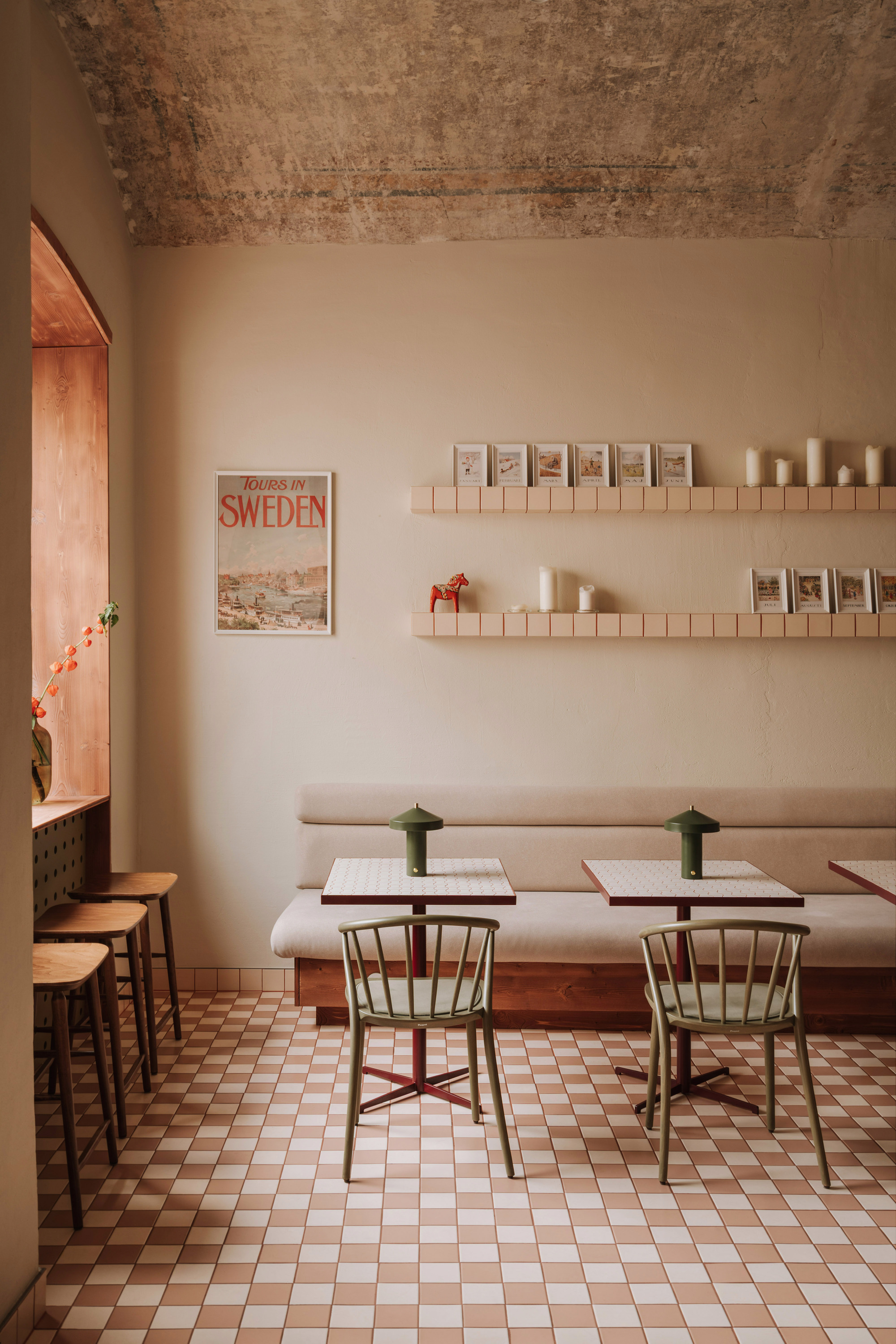 Interior seating area with exposed concrete ceiling and timber-framed arched doorway to adjacent room