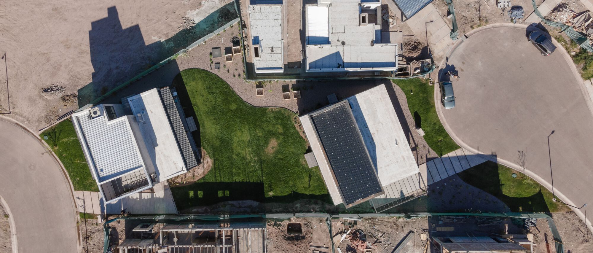 Aerial view of the two-story volume and its rear yard within the surrounding residential neighborhood
