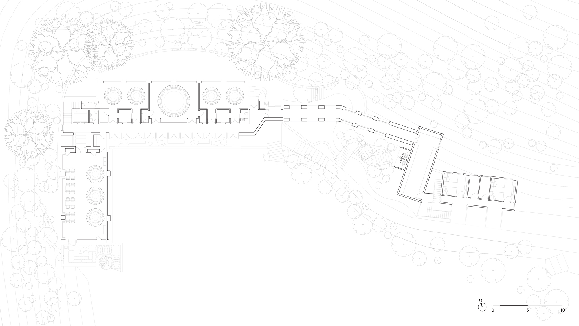 Floor plan drawing showing interior layout with circular stair and terraced passage connecting two wings