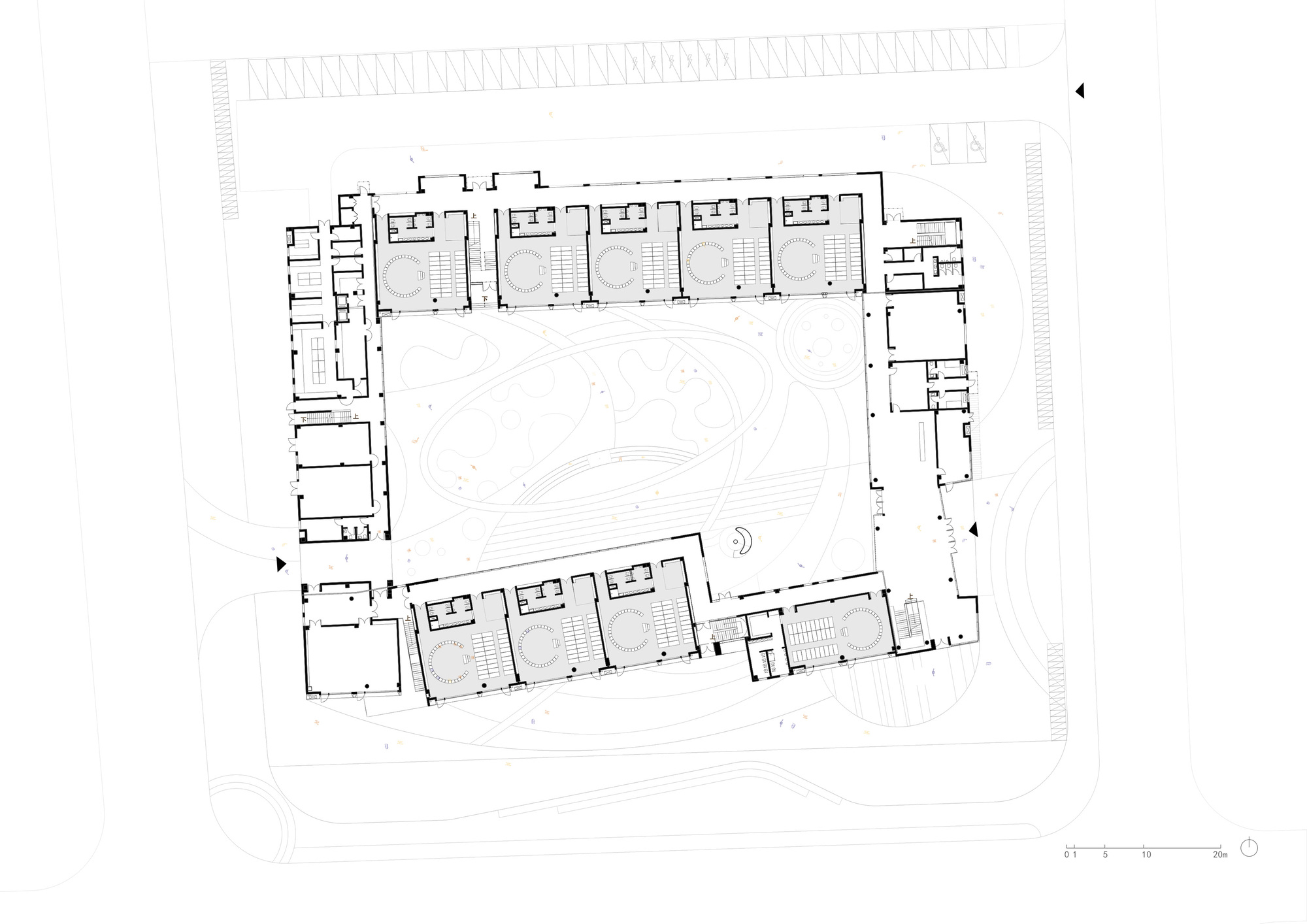 Site plan drawing showing a rectangular perimeter building enclosing a large central courtyard with topographic lines