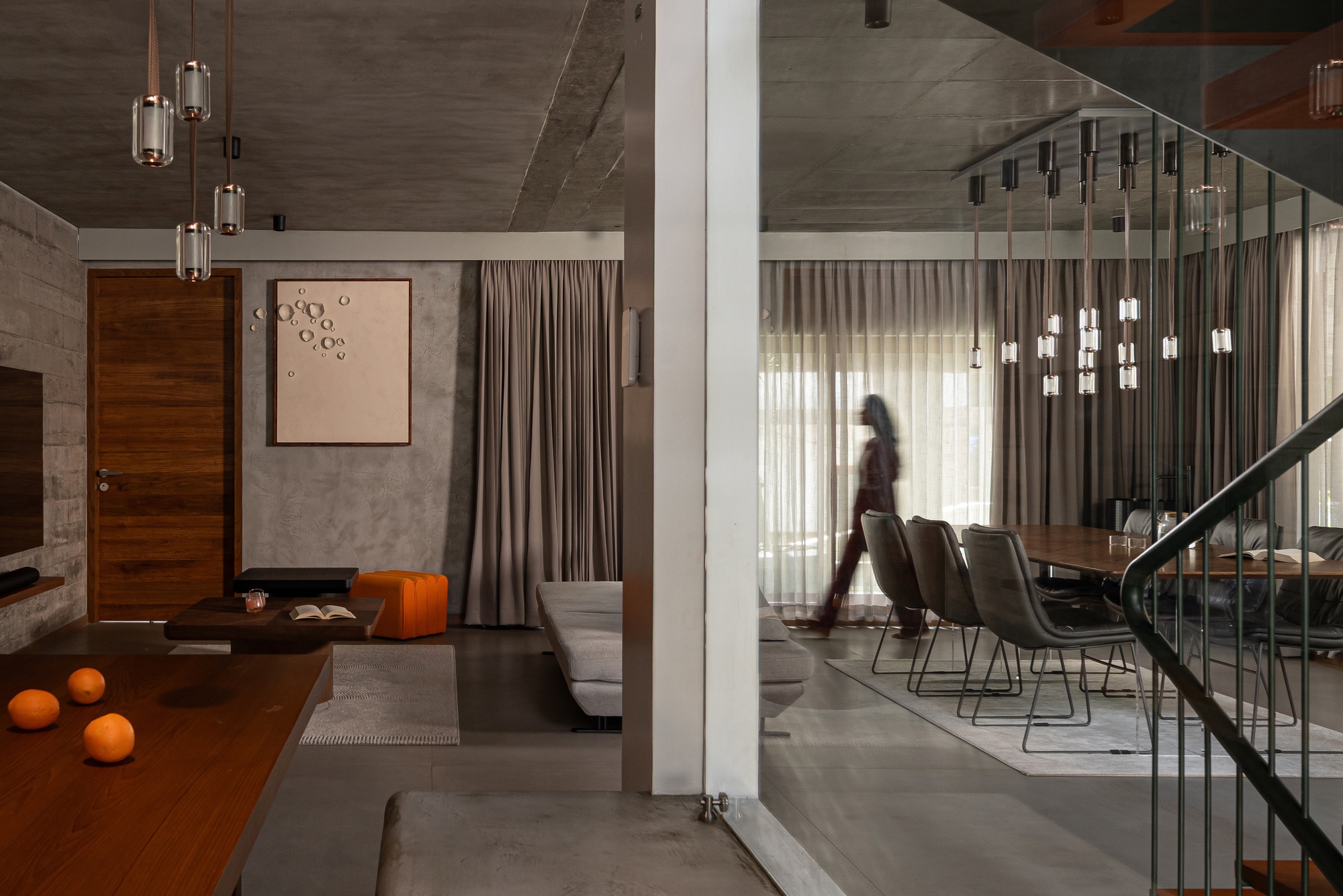 Entry foyer with board-formed concrete walls and polished concrete floor beneath exposed concrete ceiling