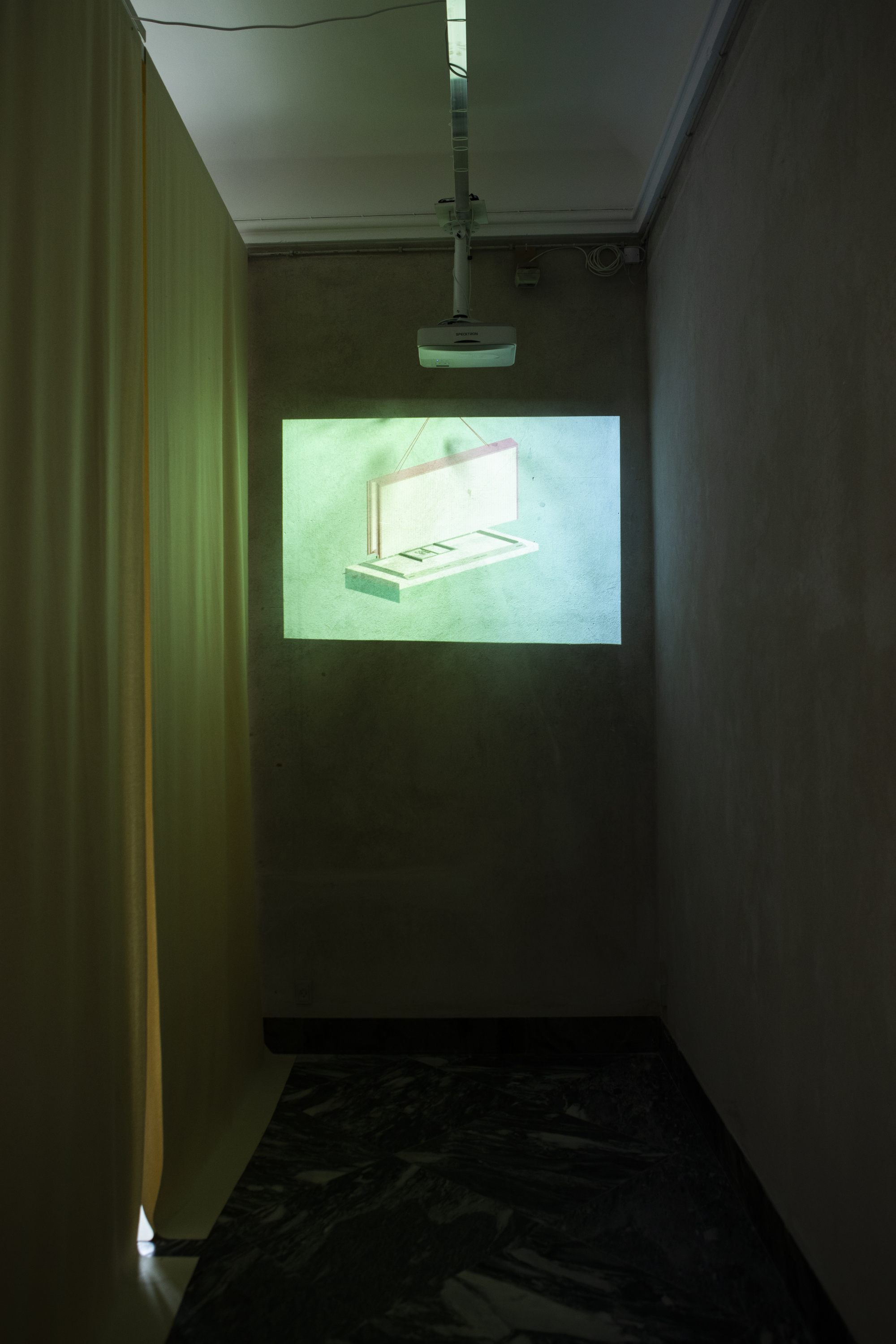 Narrow corridor with projected image of open sample case illuminated by green light
