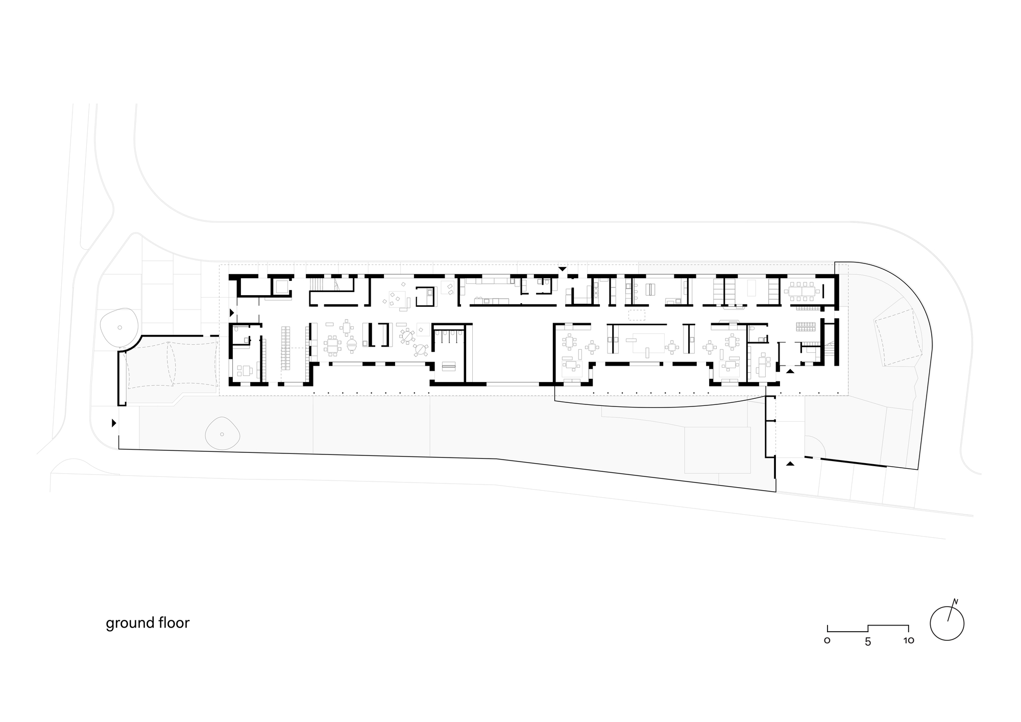 Ground floor plan drawing showing a linear arrangement of rooms with central courtyard and angular site boundary