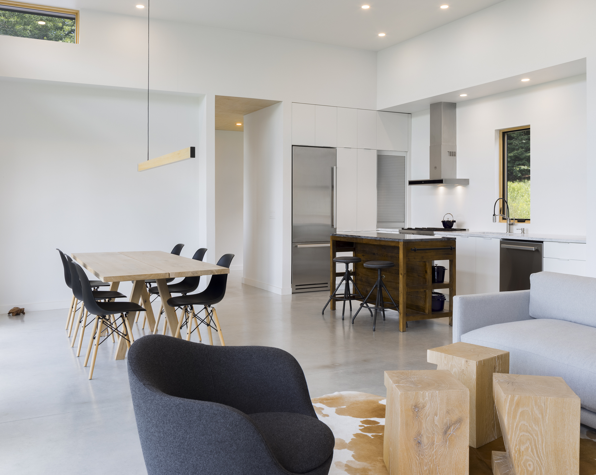 Open plan kitchen and dining area with polished concrete floor and clerestory windows