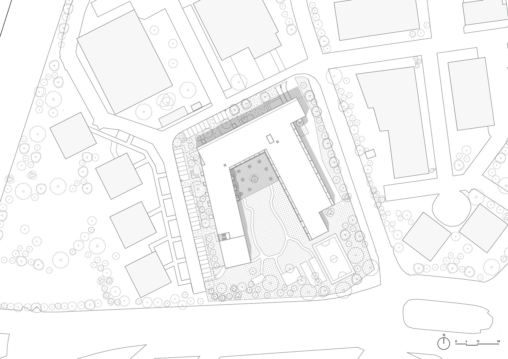 Site plan drawing showing residential building footprint with central courtyard surrounded by street trees