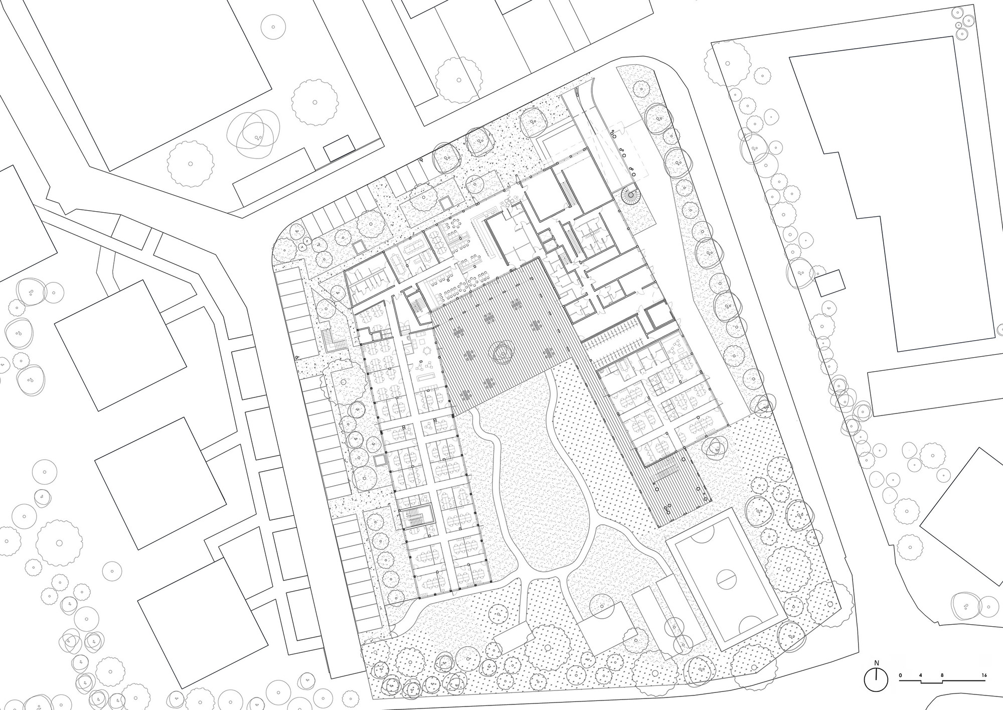 Ground floor plan drawing depicting building perimeter with interior rooms arranged around central courtyard space
