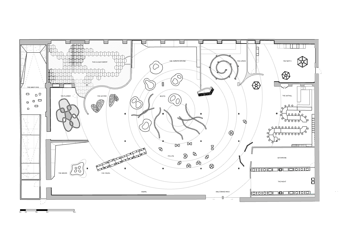 Floor plan drawing displaying circular zones with organic play elements and gridded functional areas around the perimeter
