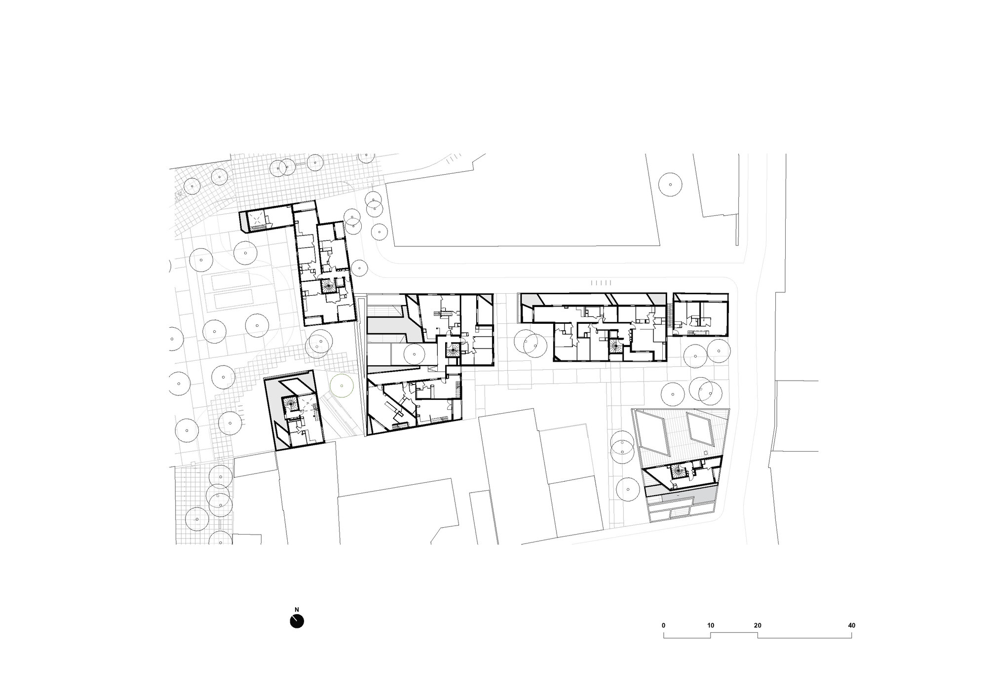 Upper floor plan drawing showing residential units distributed across connected building volumes