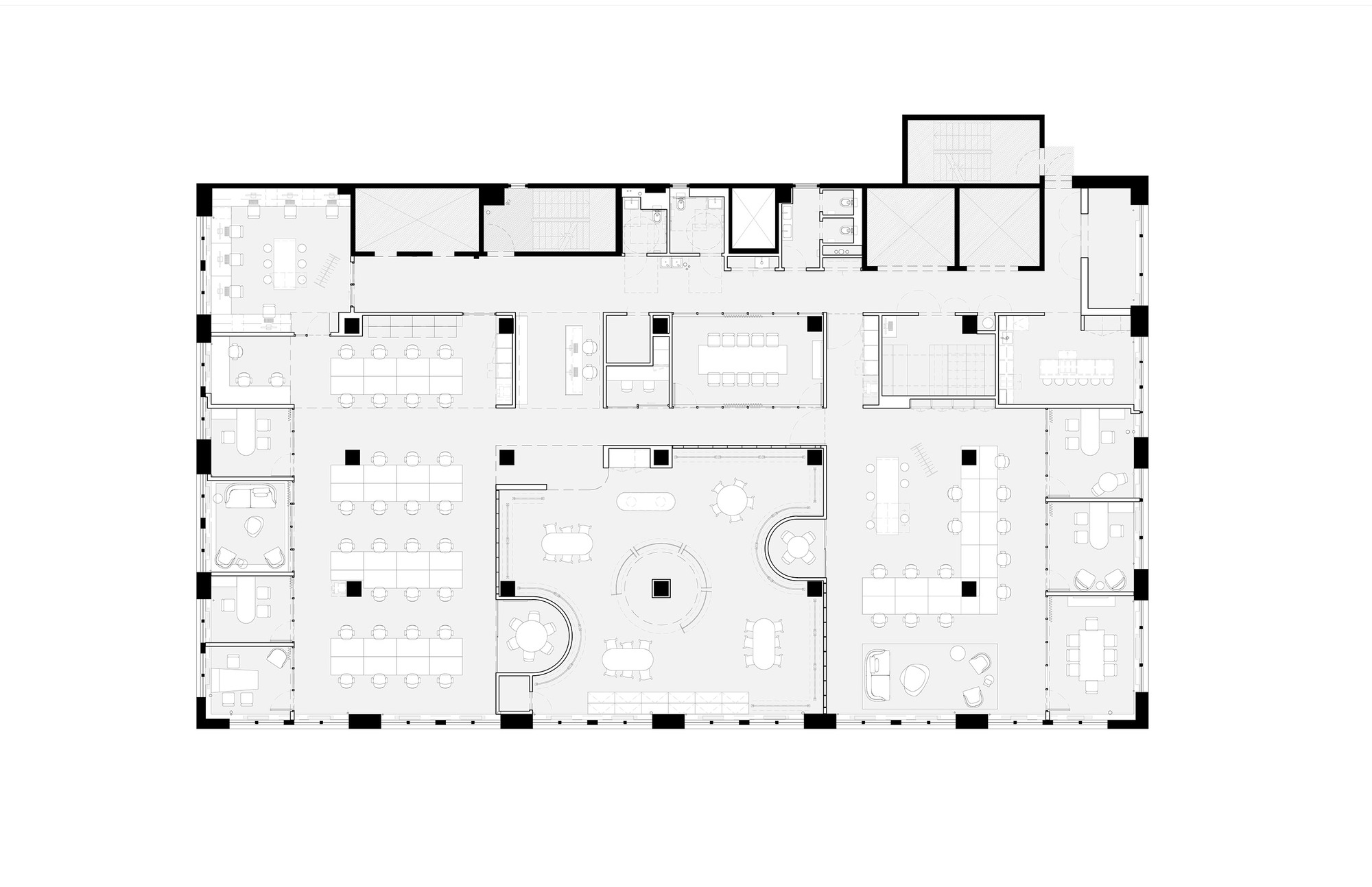 Floor plan drawing depicting an open office layout with workstations, meeting rooms, and curved interior partitions