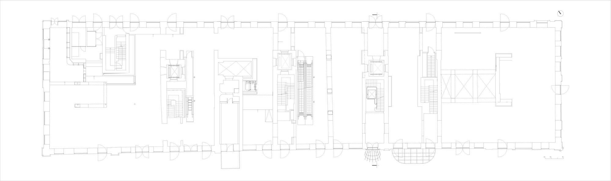 Floor plan drawing showing a long rectangular layout with central circulation and perimeter rooms