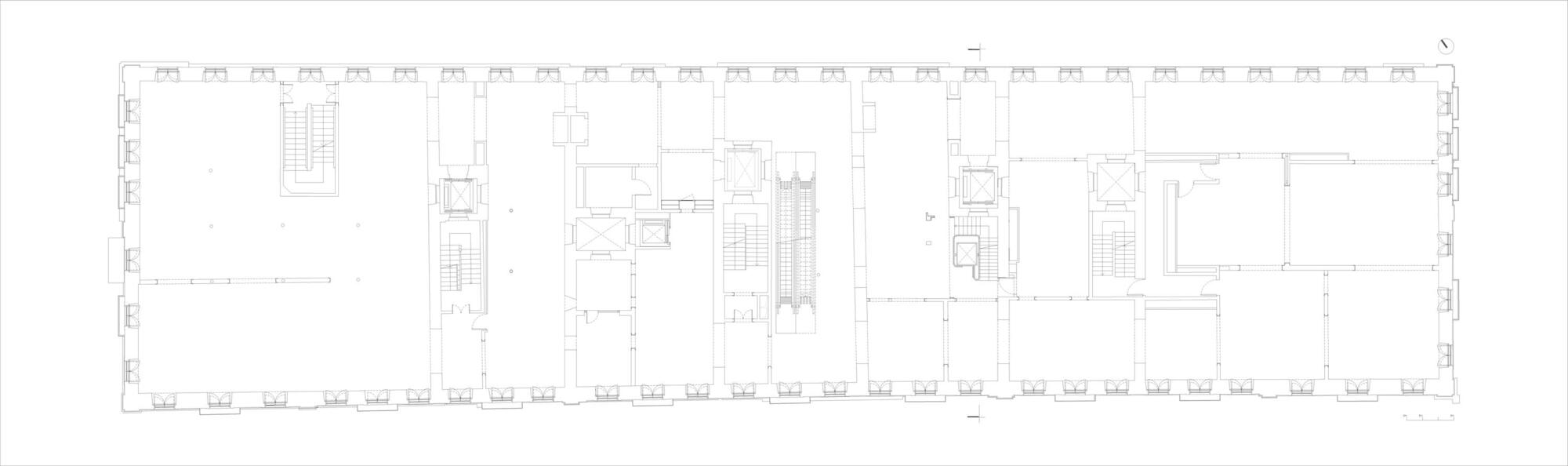 Floor plan drawing depicting an elongated space with staircases and symmetrical side chambers