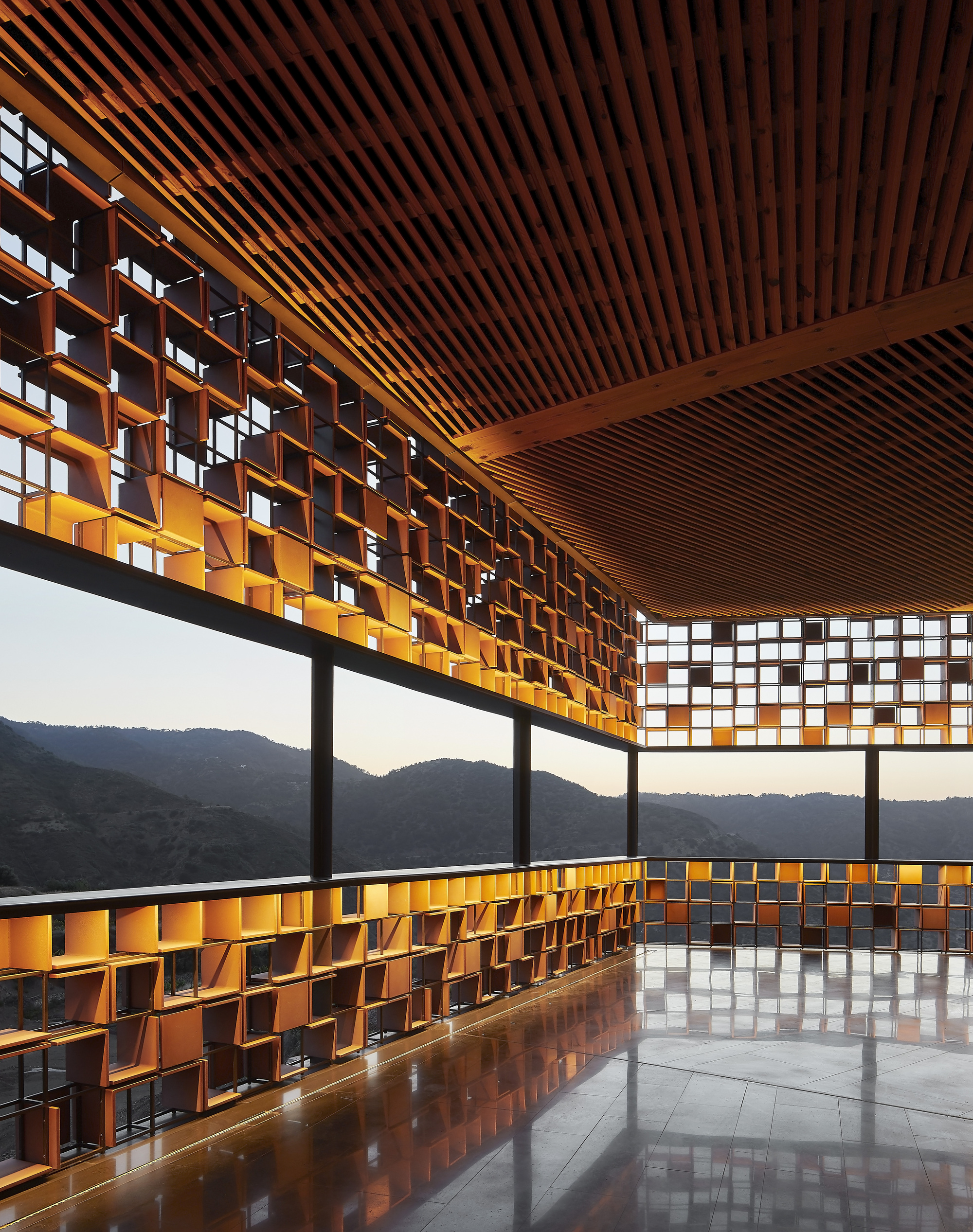Interior corner with slatted timber ceiling and perforated copper screen filtering afternoon light
