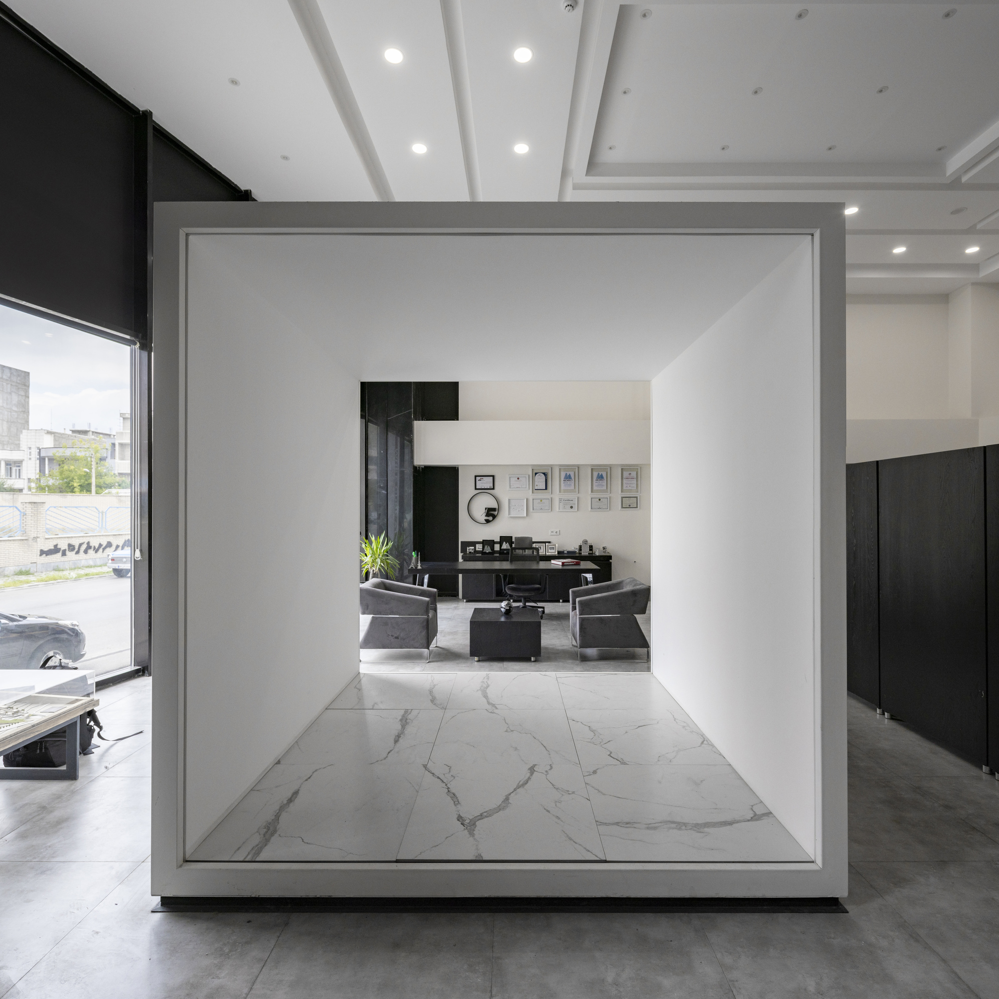 White framed volume with marble flooring viewed through a freestanding threshold in the showroom