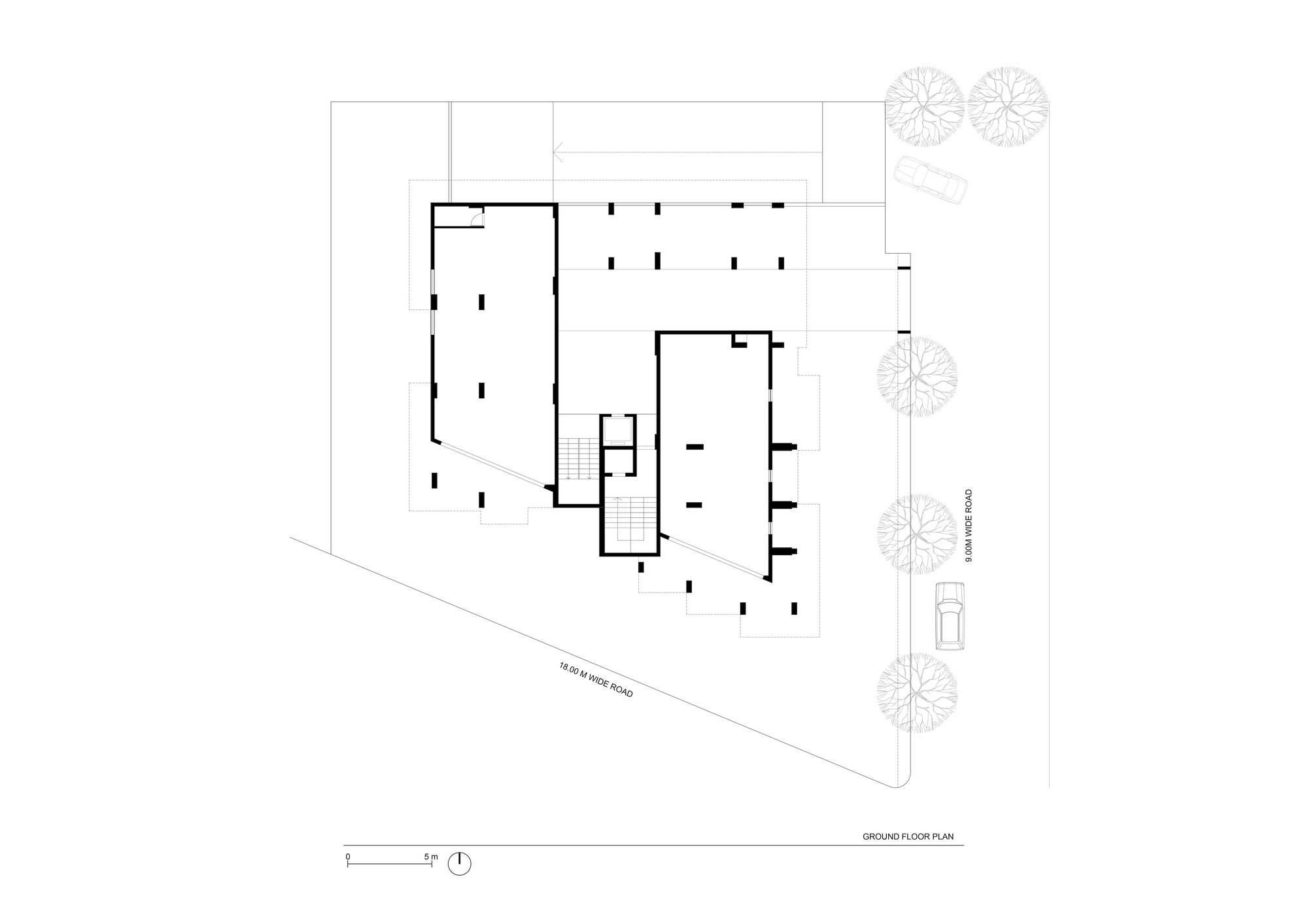 Ground floor plan drawing showing two L-shaped volumes connected by a central stairwell with adjacent street trees