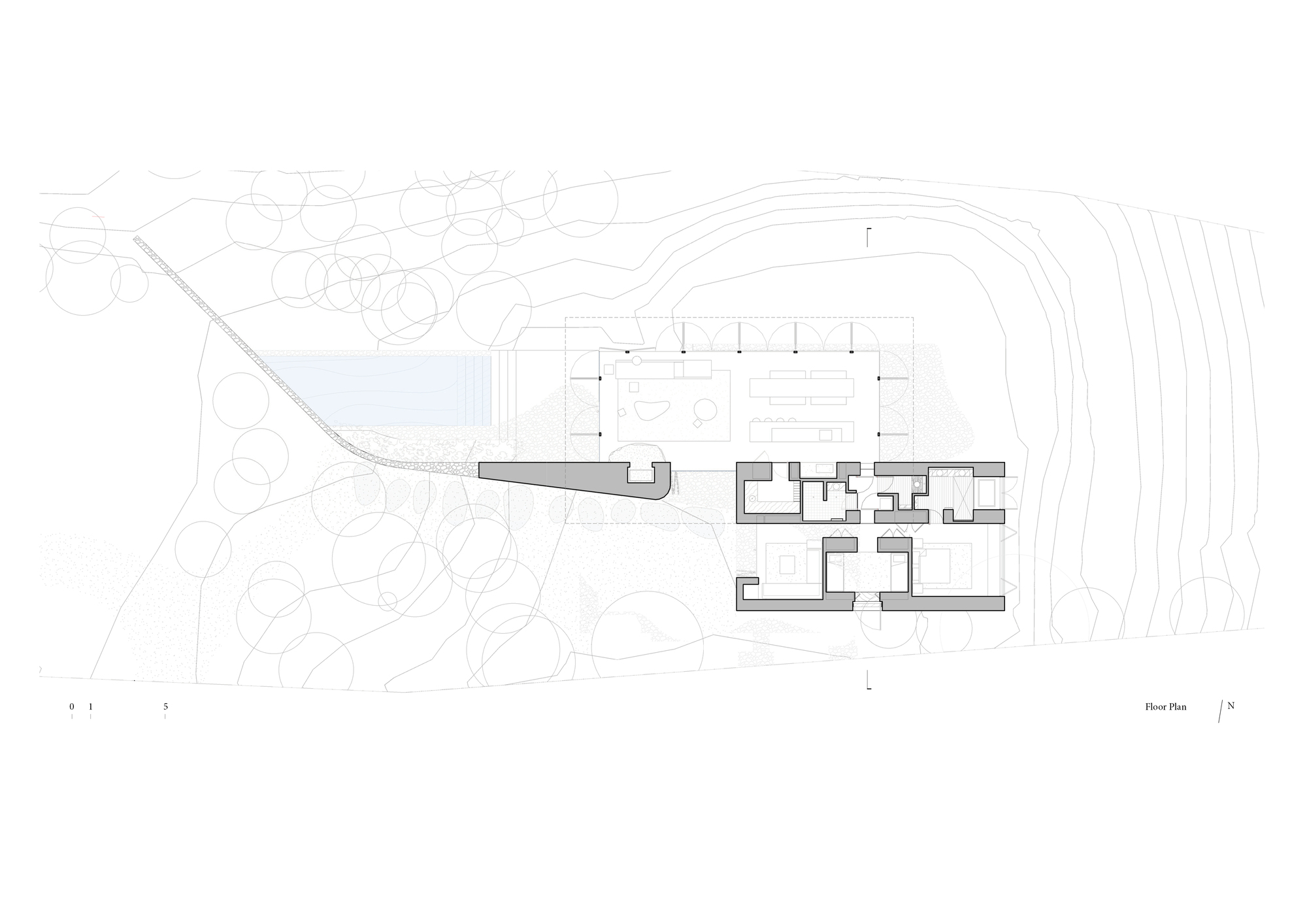 Floor plan drawing showing building volumes on a sloping site with topography and vegetation