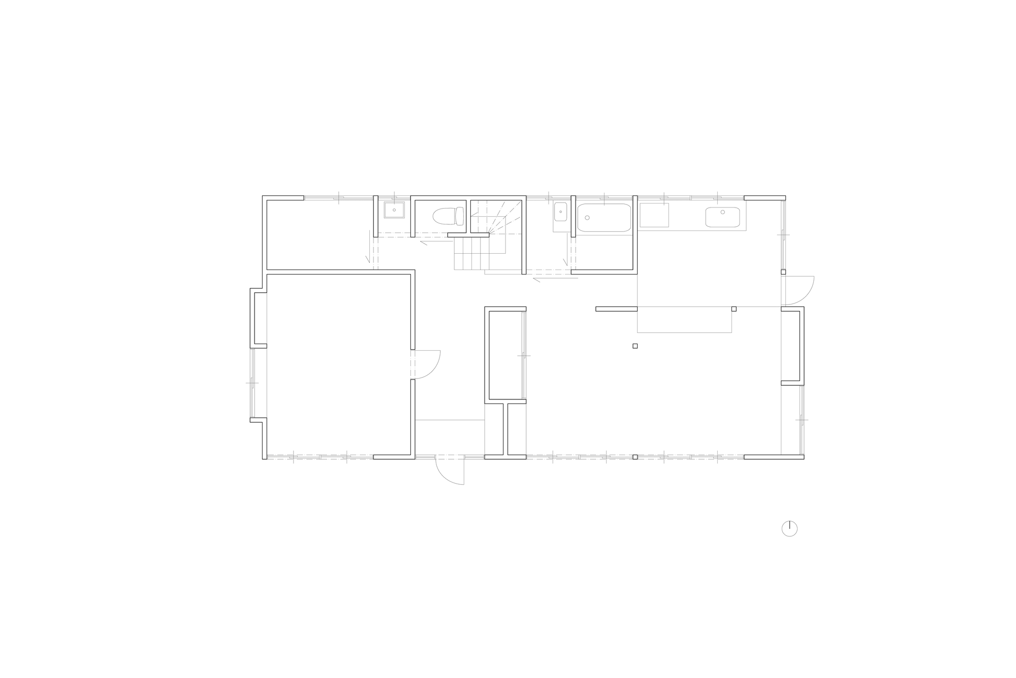 Floor plan drawing showing a rectangular layout with central stair, bathroom cluster, and open living space