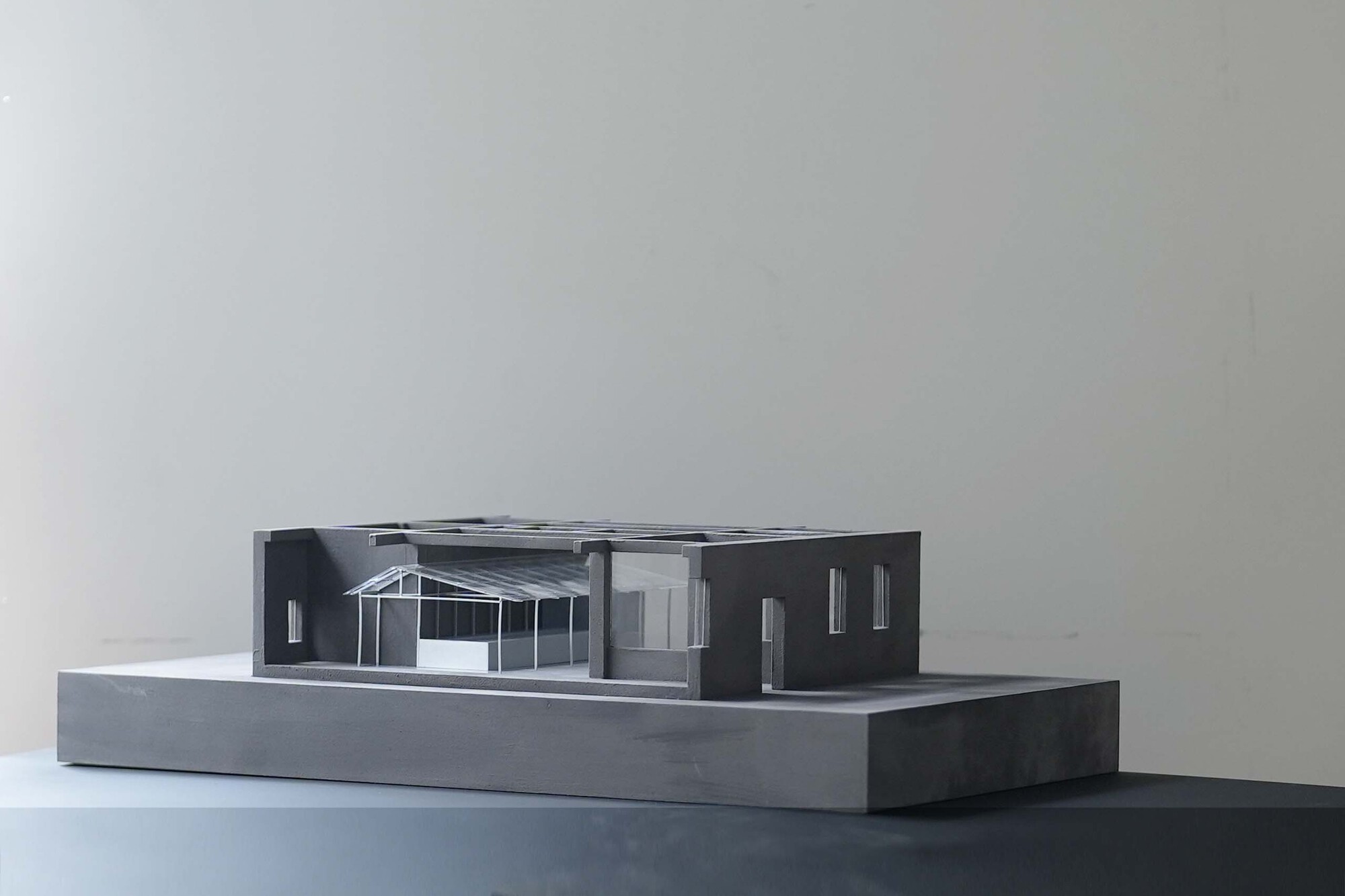 Physical model showing sectional cut through single-story structure with exposed roof framing