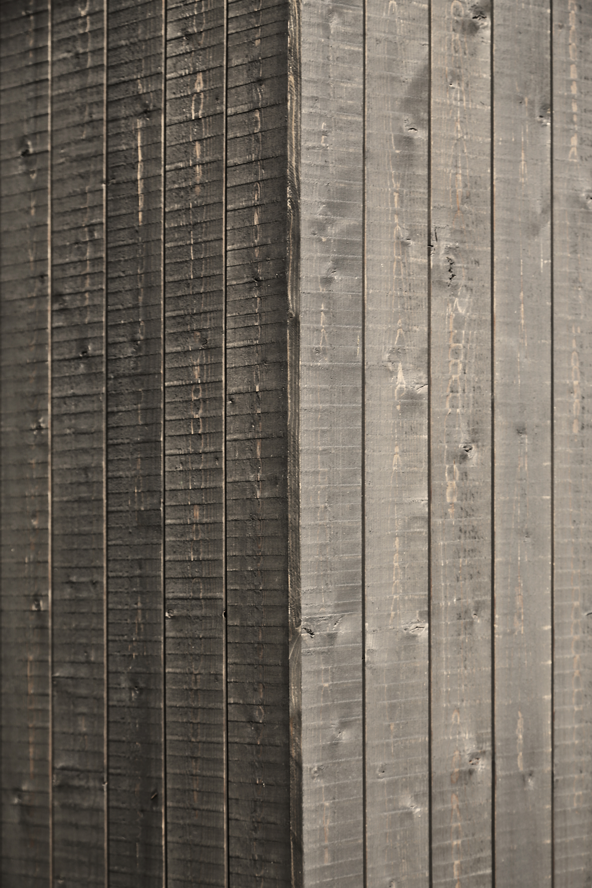 Close-up of charred timber cladding showing vertical grooves and weathered texture