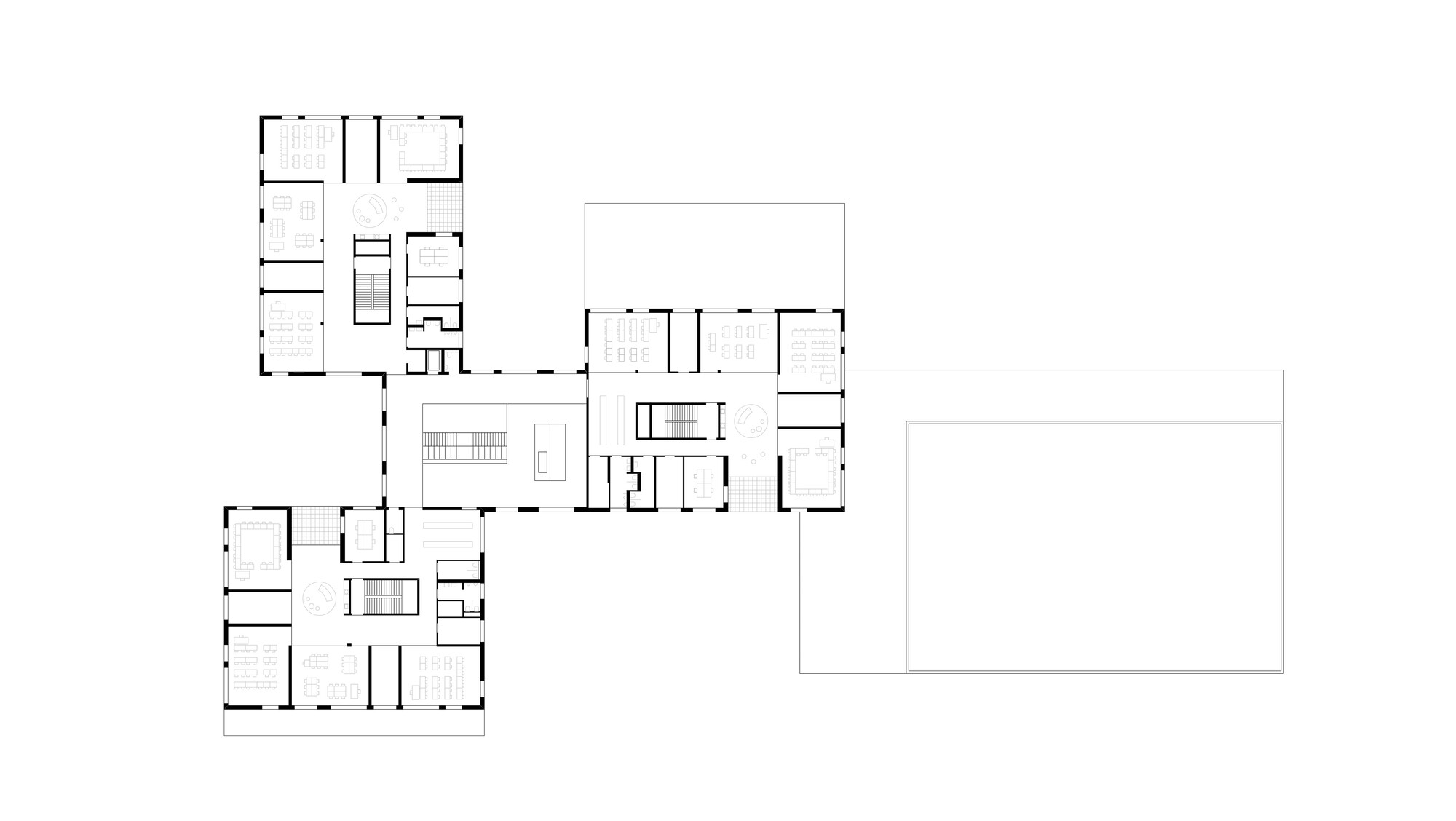 Floor plan drawing showing clustered wings around a central circulation core with a large rectangular volume