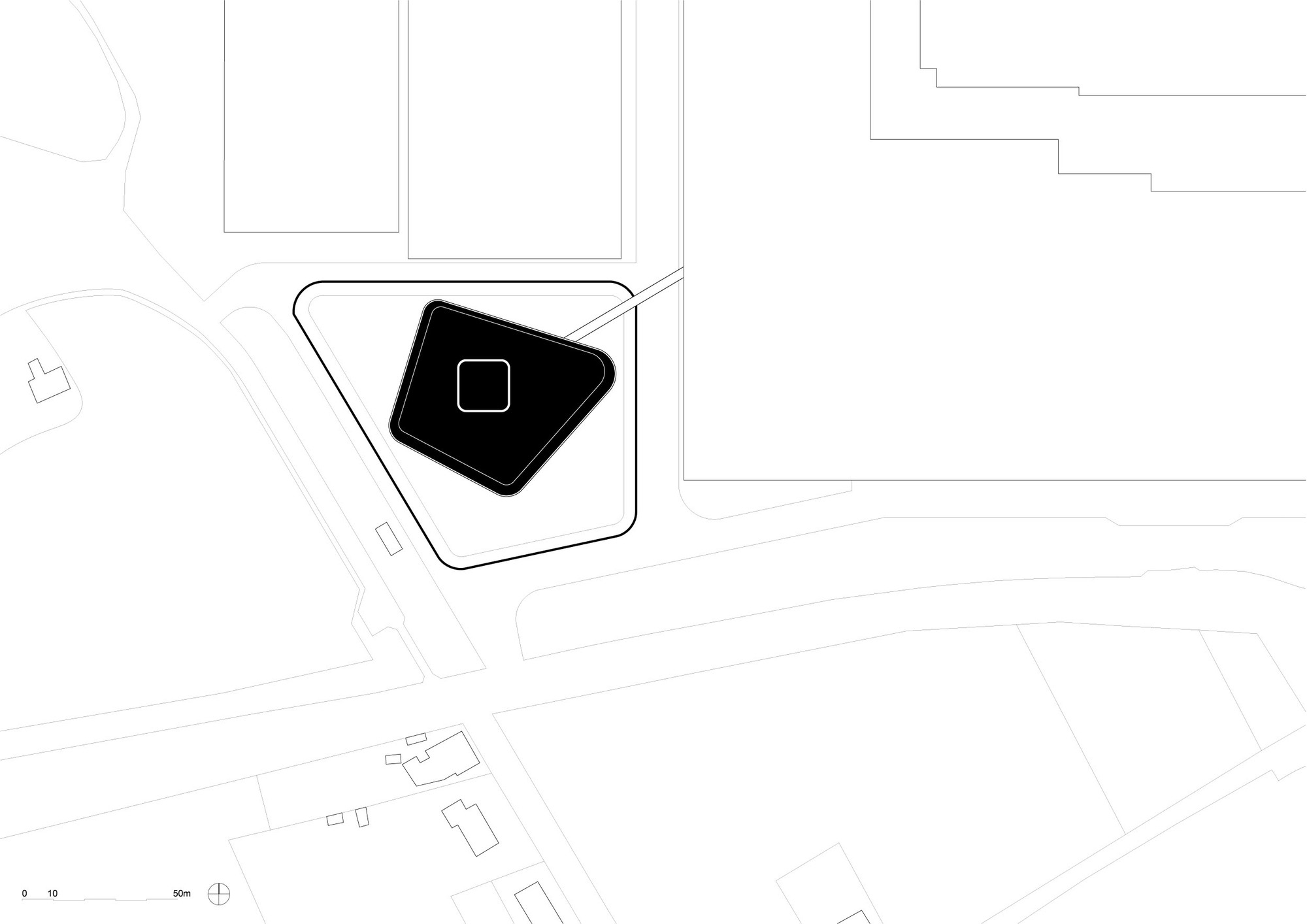 Site plan drawing showing an angular building footprint with central courtyard and surrounding context