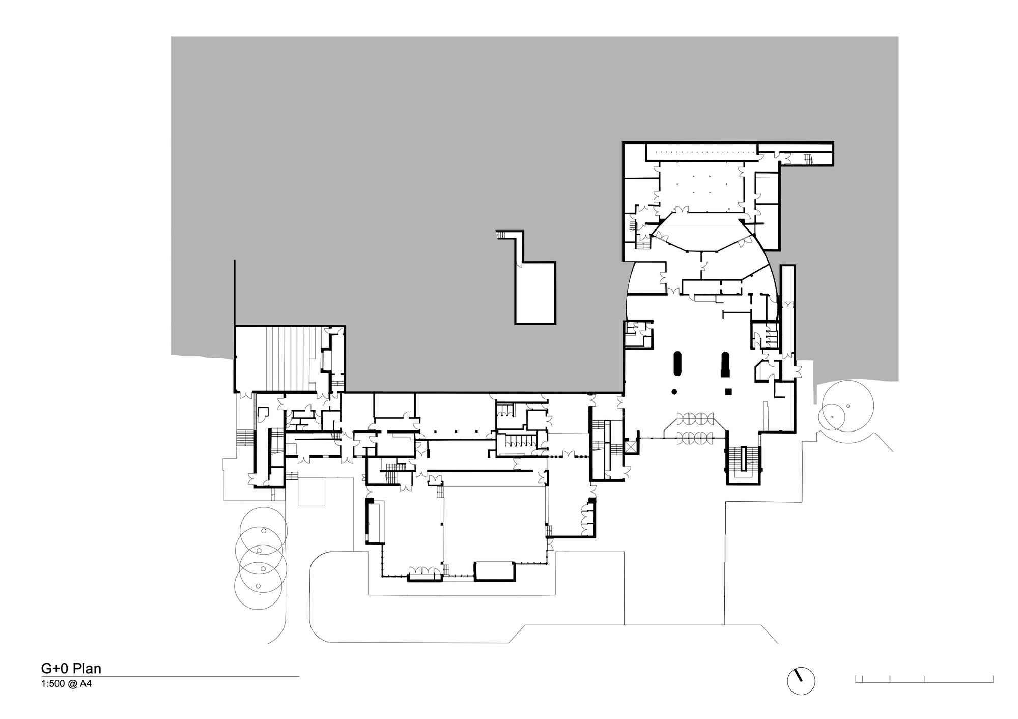 Ground floor plan drawing showing interconnected rooms with central circulation and theater space