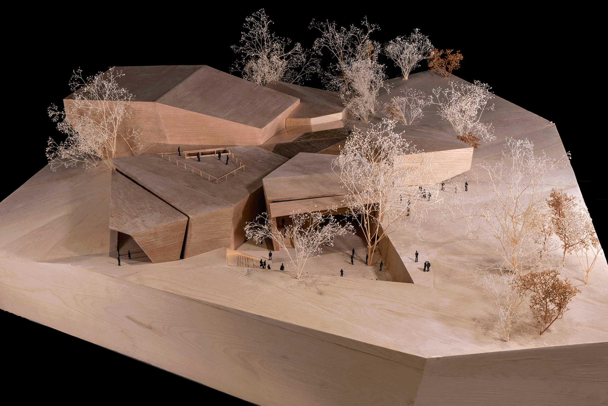 Physical model showing three interlocking volumes with courtyard and white miniature trees throughout