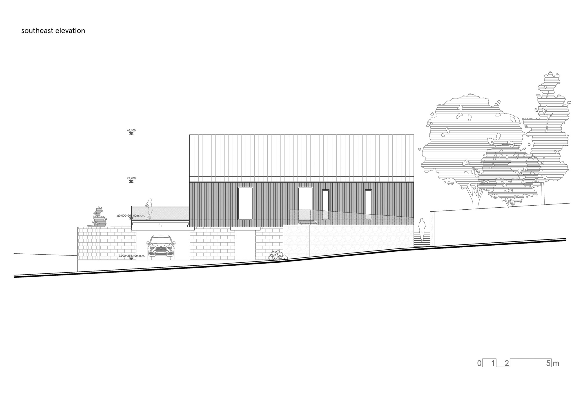 Southeast elevation drawing showing the vertical cladding and masonry base on sloping terrain