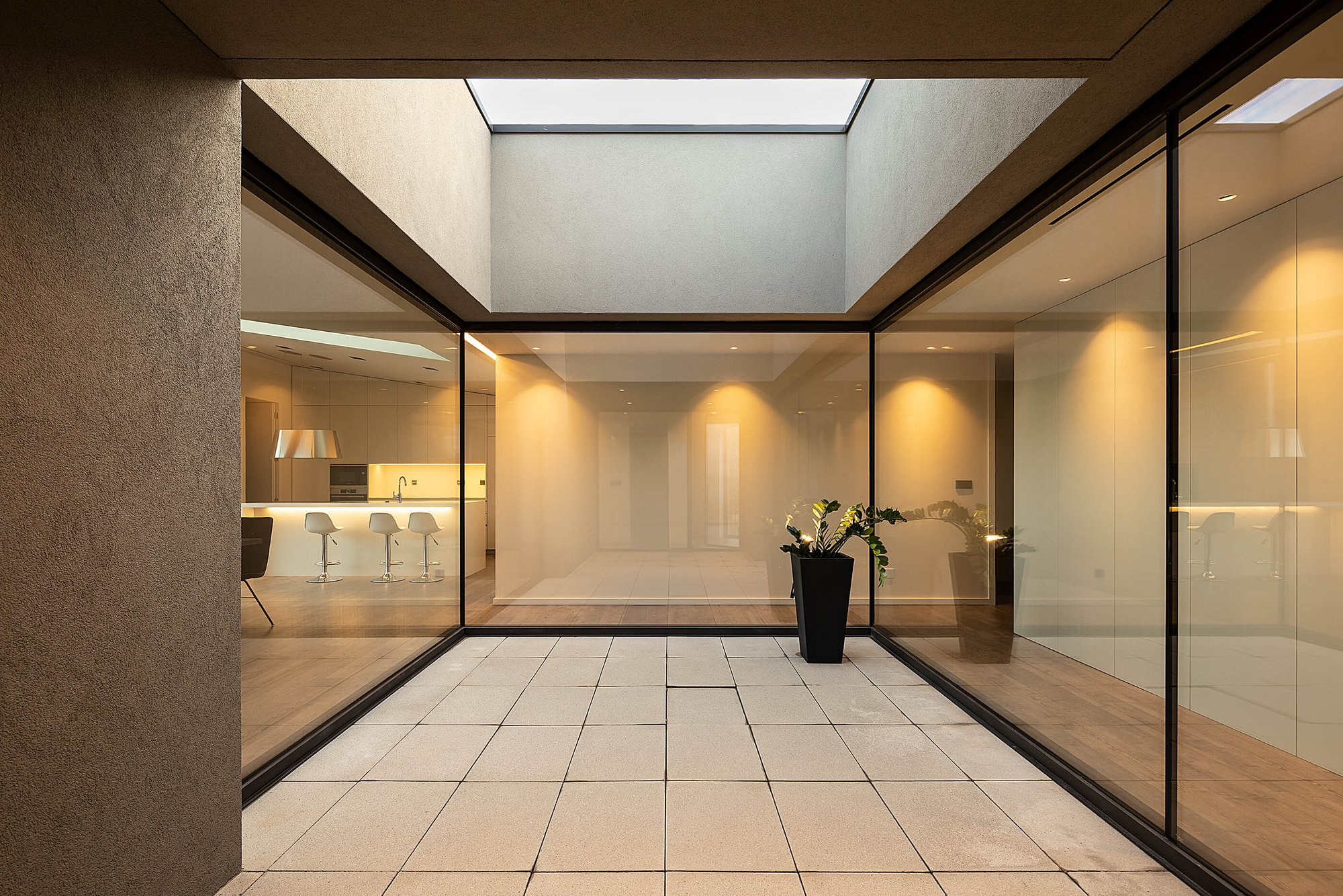 Central courtyard with skylight brings controlled daylight into the core living areas.