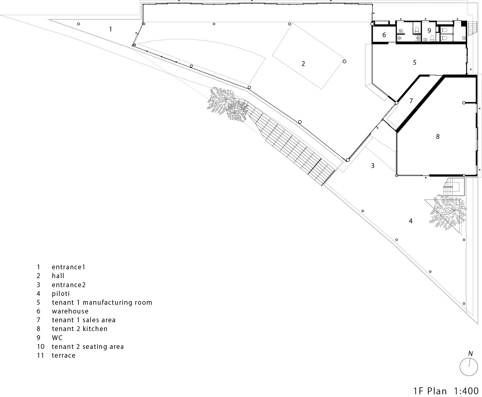 First floor plan drawing showing angled building footprint with labeled entrances, hall, and seating areas