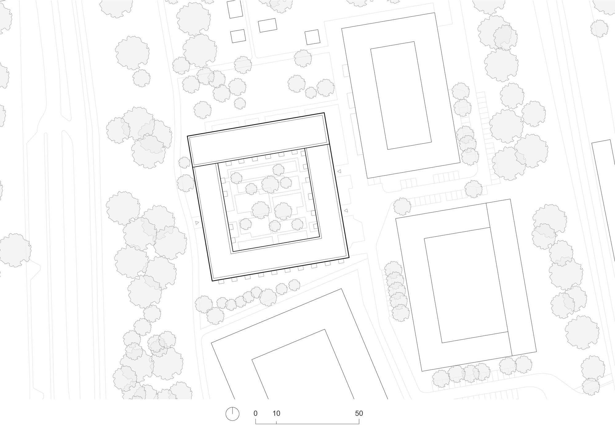 Site plan drawing showing four rectangular volumes arranged among existing trees and pathways