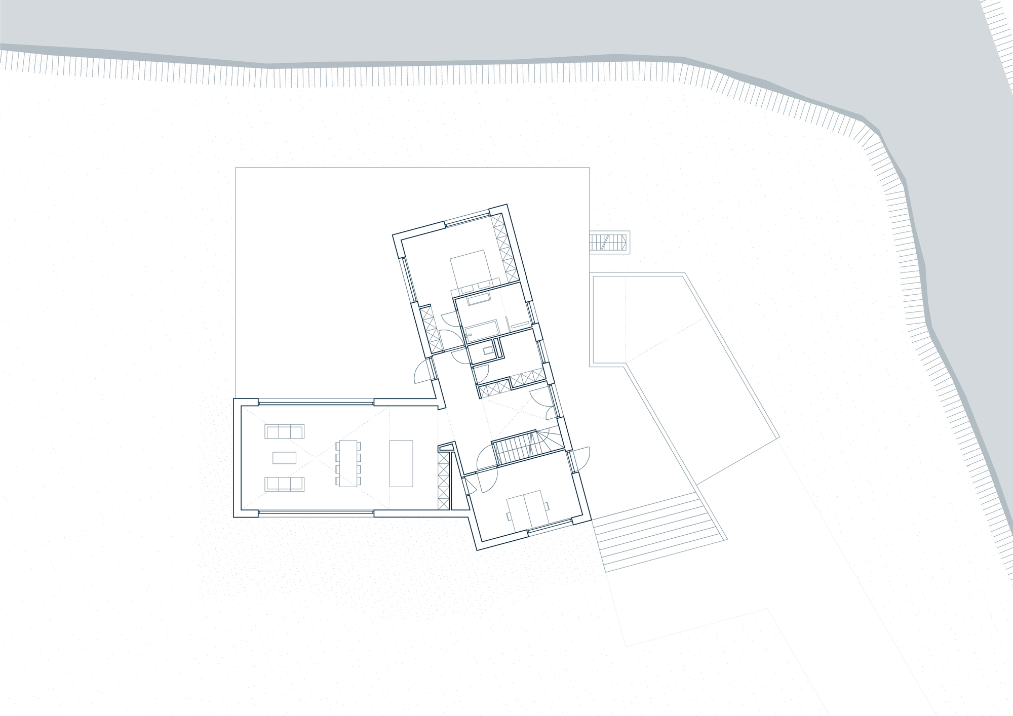Floor plan drawing showing residence with angled volumes and adjacent curved topography