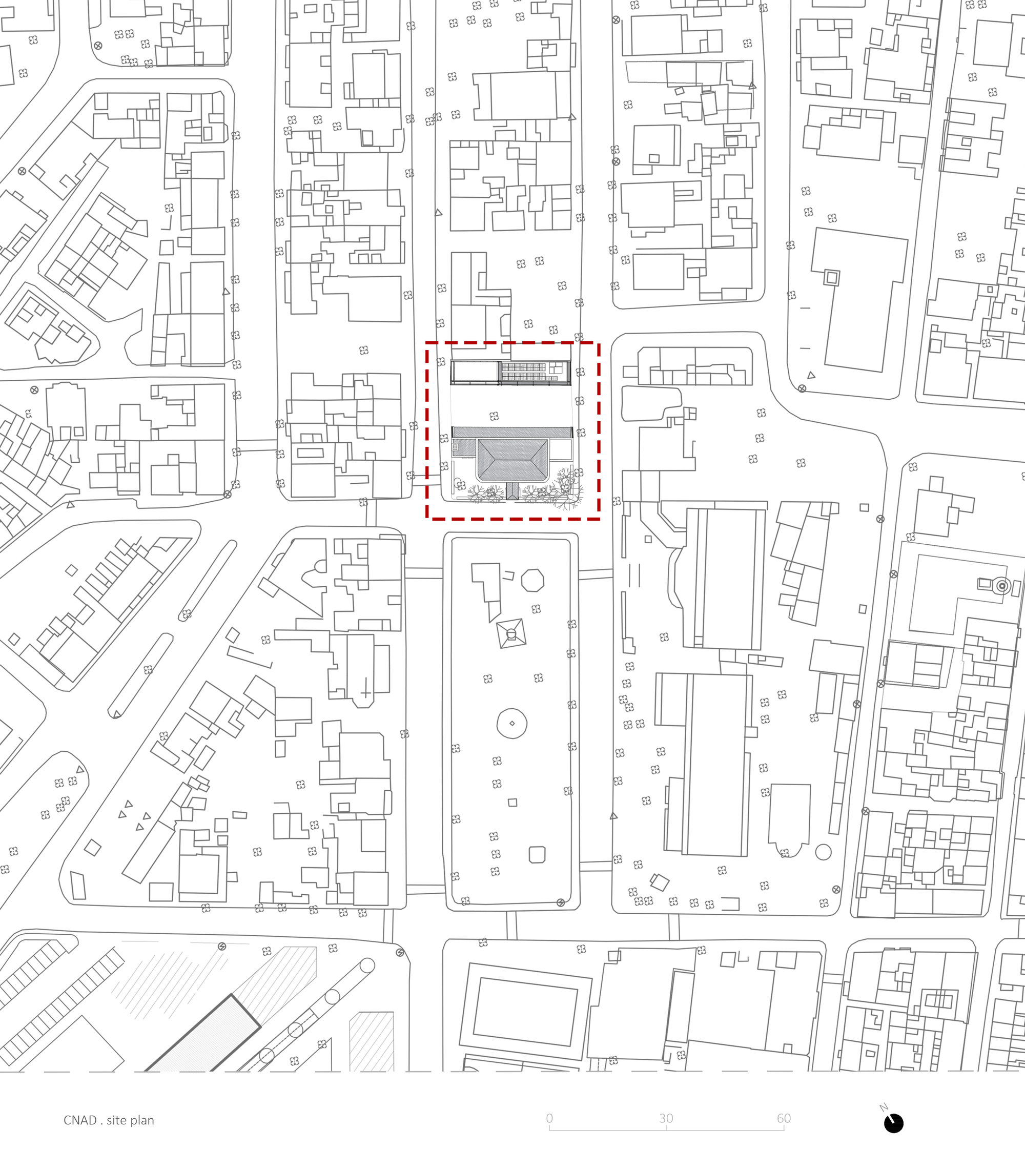 Site plan drawing showing a rectangular building footprint outlined in red within the surrounding urban block