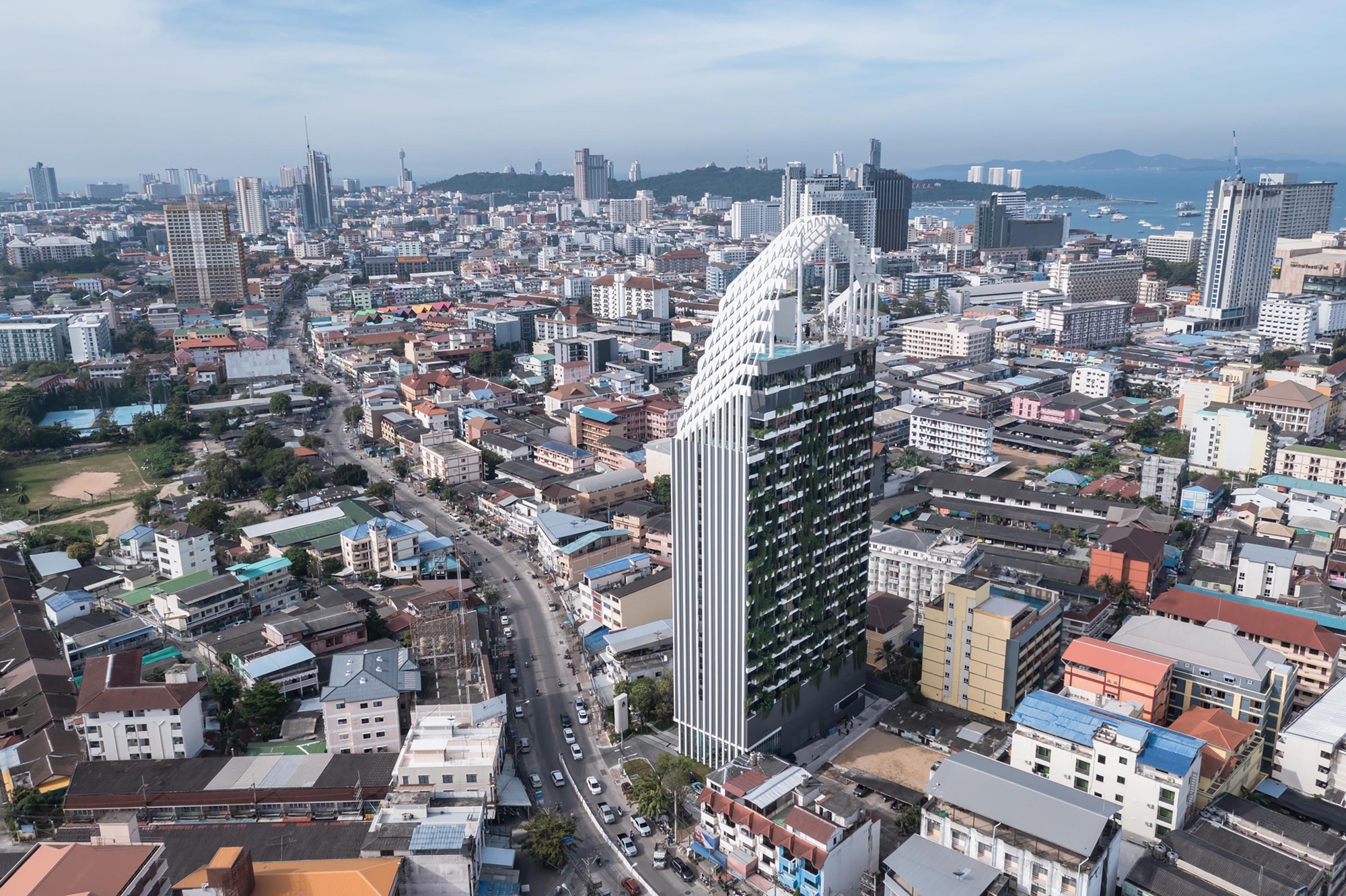 Aerial view of the tower rising above surrounding low-rise urban fabric with the bay in the distance