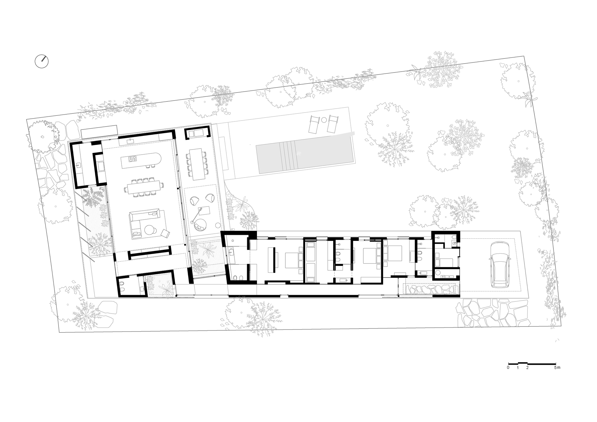Floor plan drawing showing an L-shaped residence with interior rooms and surrounding landscape