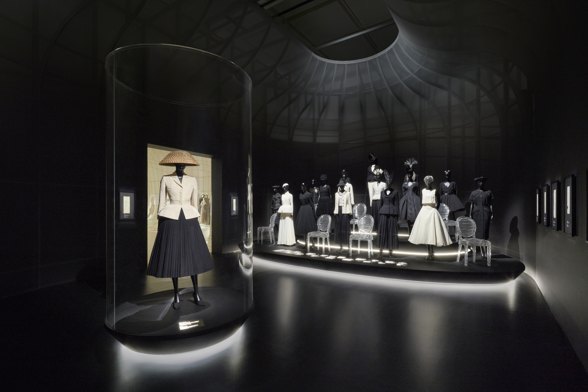 Cylindrical display vitrine with spot lighting in a dark circular gallery space