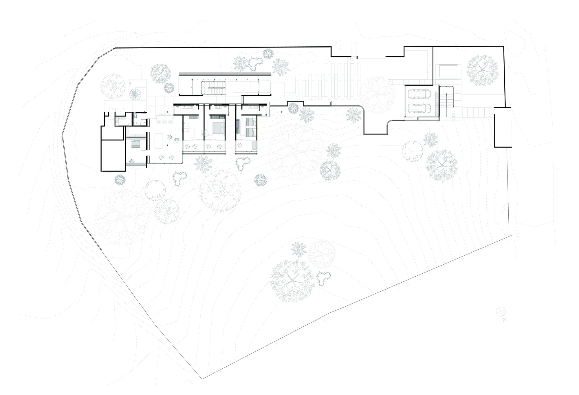 Site plan drawing showing clustered pavilions on an irregular lot with scattered tree canopies