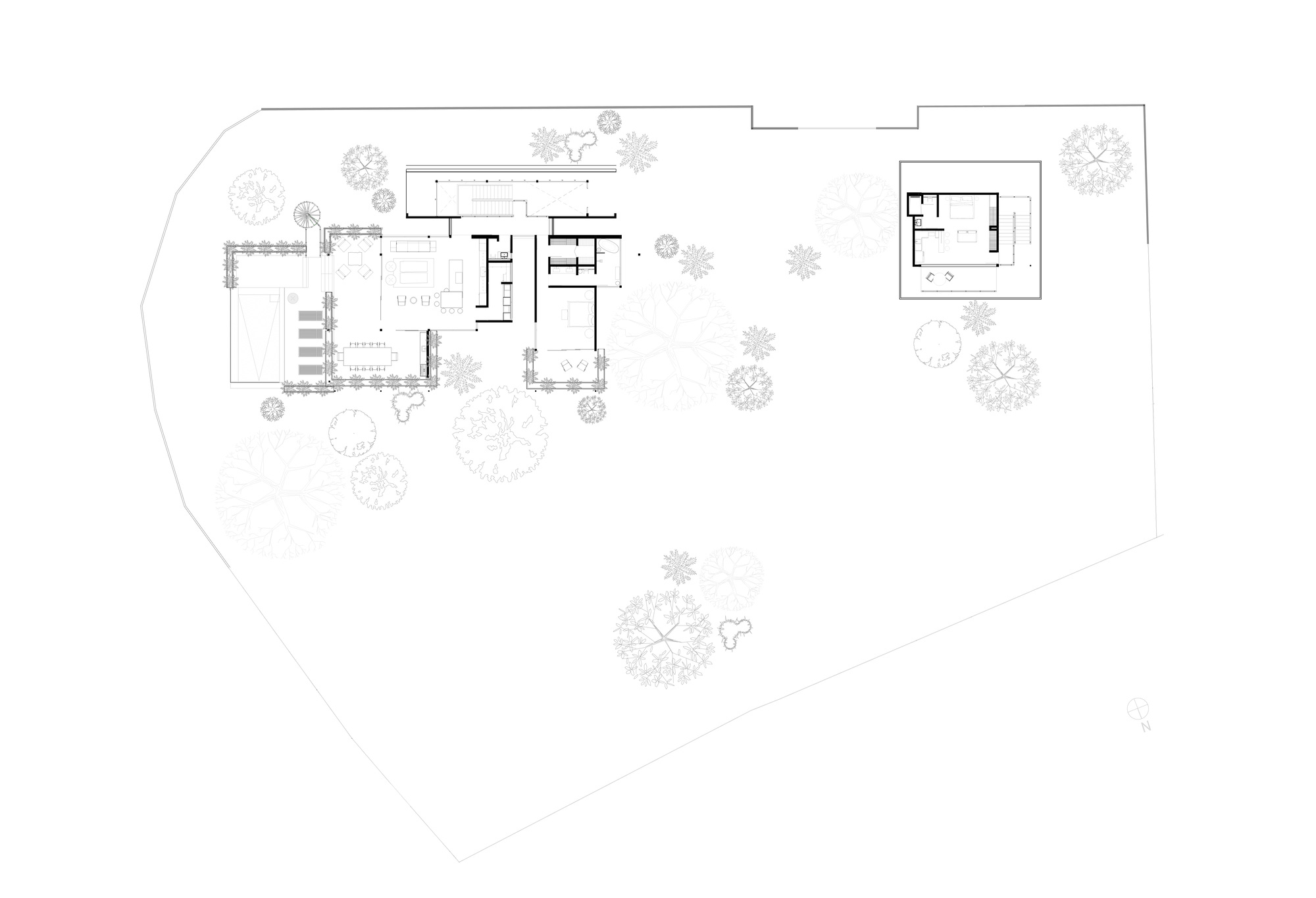 Floor plan drawing showing main living pavilion and detached guest structure among landscape planting