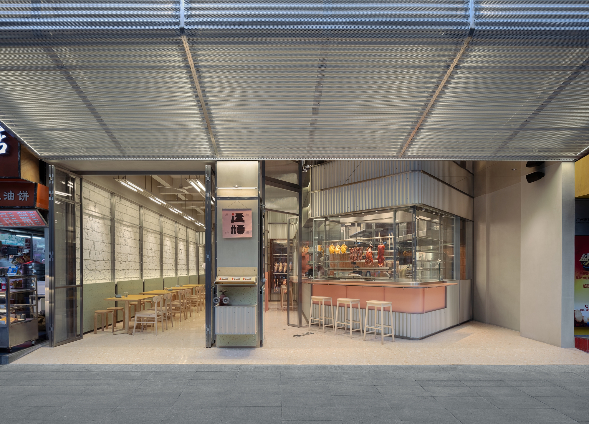 Covered entrance with corrugated metal canopy and open storefront revealing the tiled interior and service counter