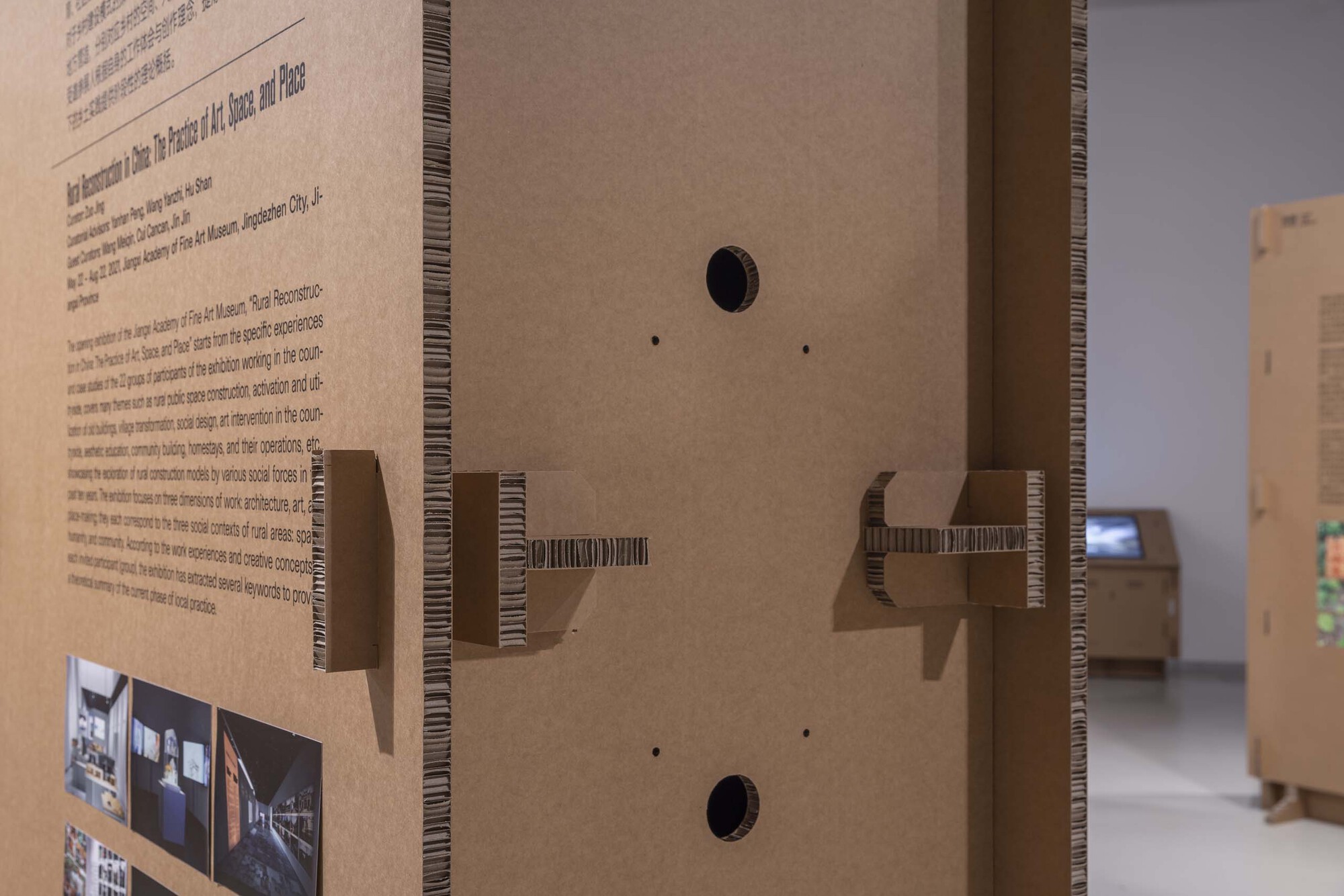 Detail of corrugated cardboard edge with cantilevered shelf brackets and circular cable ports